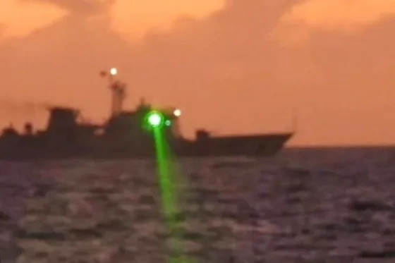 A Chinese coast guard vessel shines a 