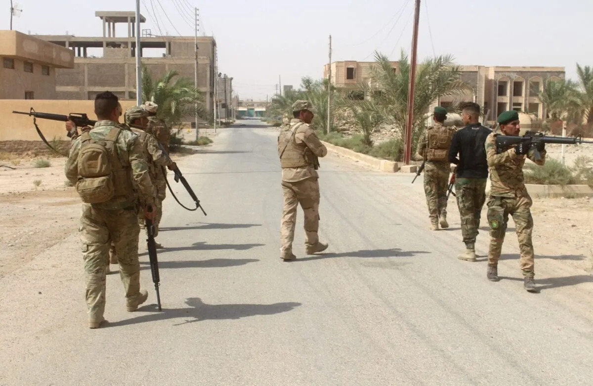 Iraqi forces members patrol during a military operation in Anbar province