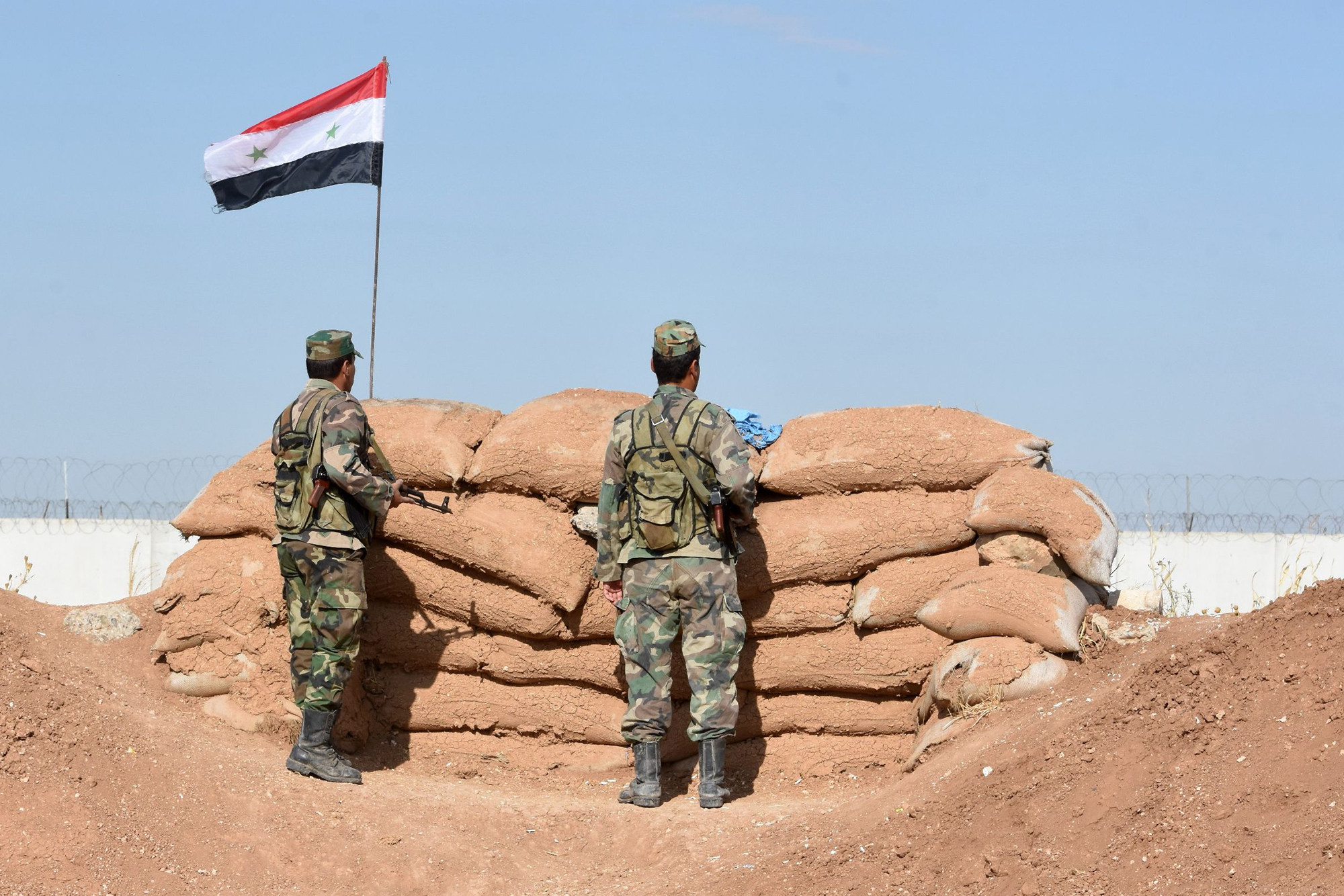 Syrian regime forces manning a position in the countryside city of Kobane, also known as Ain al-Arab, along the border with Turkey