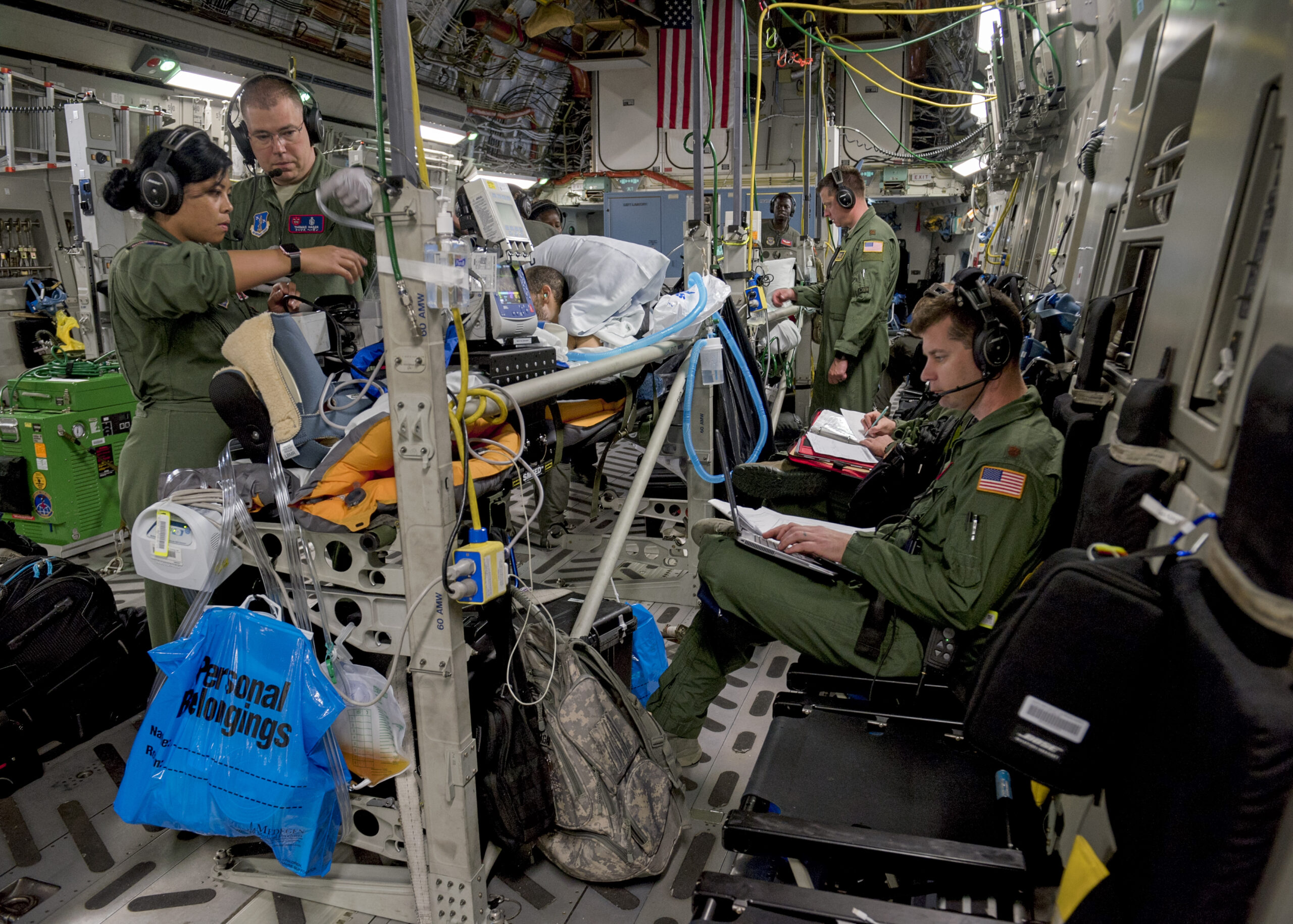Critical care air transport teams and aeromedical evacuation teams provide medical care and attention to patients onboard a C-17 Globemaster III from Travis Air Force Base, Calif., after leaving Joint Base Pearl Harbor-Hickam, Hawaii, May 18, 2018. The C-17 was configured by an AE aircrew to provide aerial transport of patients throughout the Pacific region. (U.S. Air Force photo by Lan Kim)