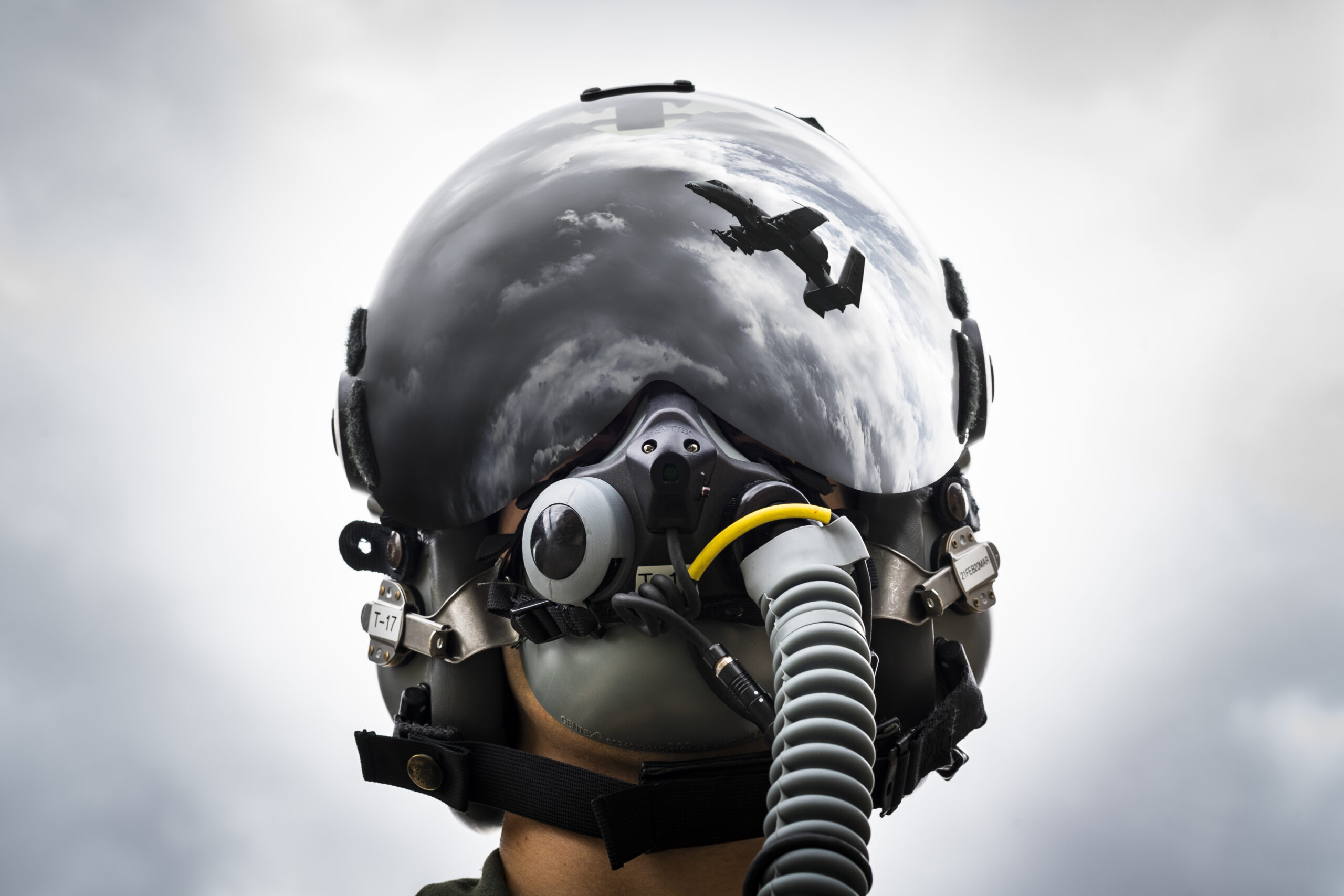 1st Lt. Anton King, 75th Fighter Squadron pilot, poses for a photo wearing an HGU-55/P helmet fitted with Hybrid Optical-based Inertial Tracker and day visor Feb. 11, 2020, at Moody Air Force Base, Georgia. The helmet provides A-10C Thunderbolt II pilots a central interface for everything they need, from oxygen supply to communications to flight instruments. (U.S. Air Force photo illustration by Airman 1st Class Hayden Legg) (This image was manipulated by merging two photos in Adobe Photoshop.)