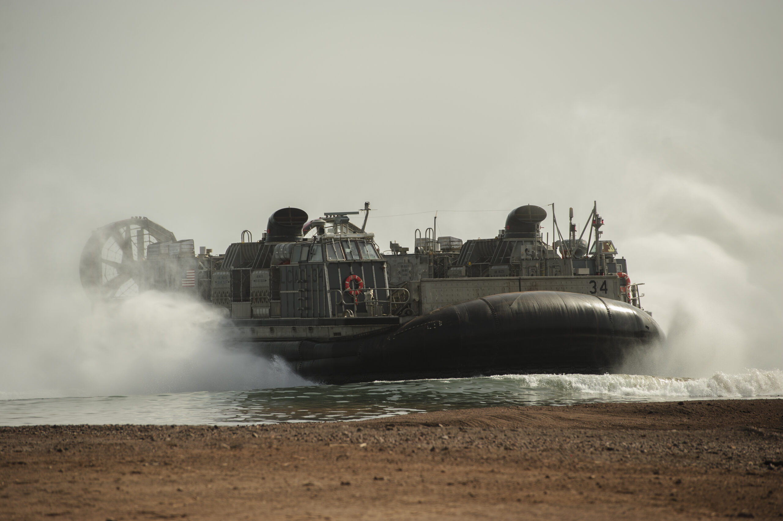 A land craft, air cushioned vessel (LCAC) from the USS Kearsarge (LHD 3) lands on Arta Beach to transport members of the 26th Marine Expeditionary Unit, light armored vehicles and Humvees to the ship during a regular rotation of forces to support maritime security operations, provide crisis response capability, and increase theater security cooperation, Djibouti, May 30, 2013. An LCAC (hovercraft) is used for seamless transport of assets from ship to shore and across the beach. (U.S. Air Force photo by Staff Sgt. Julianne M. Showalter)