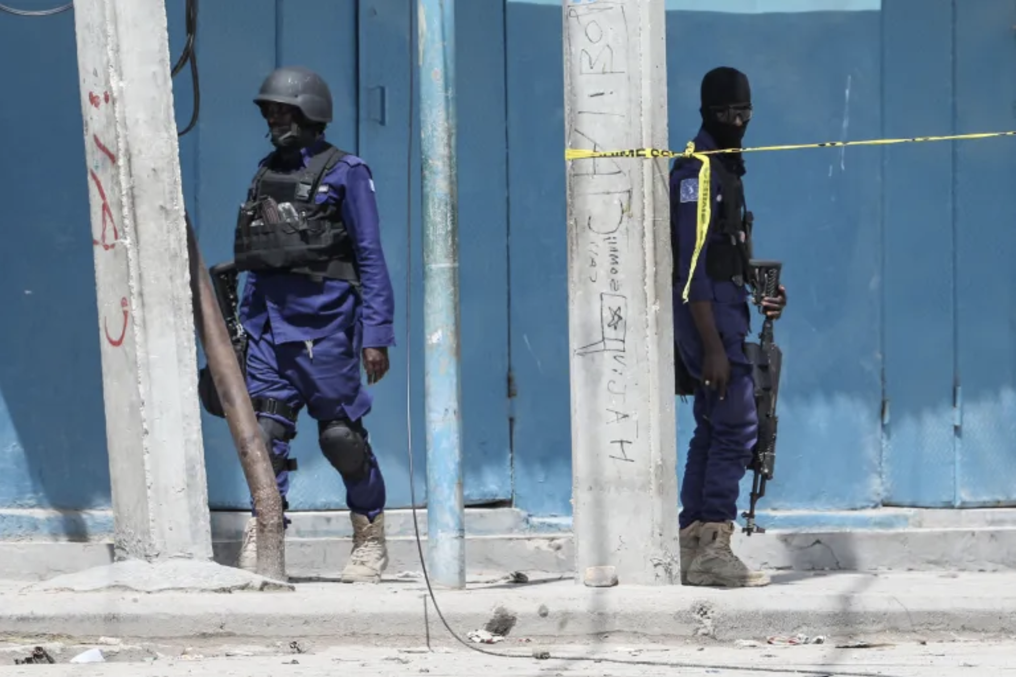 Security officers patrol at the the site of explosions in Mogadishu