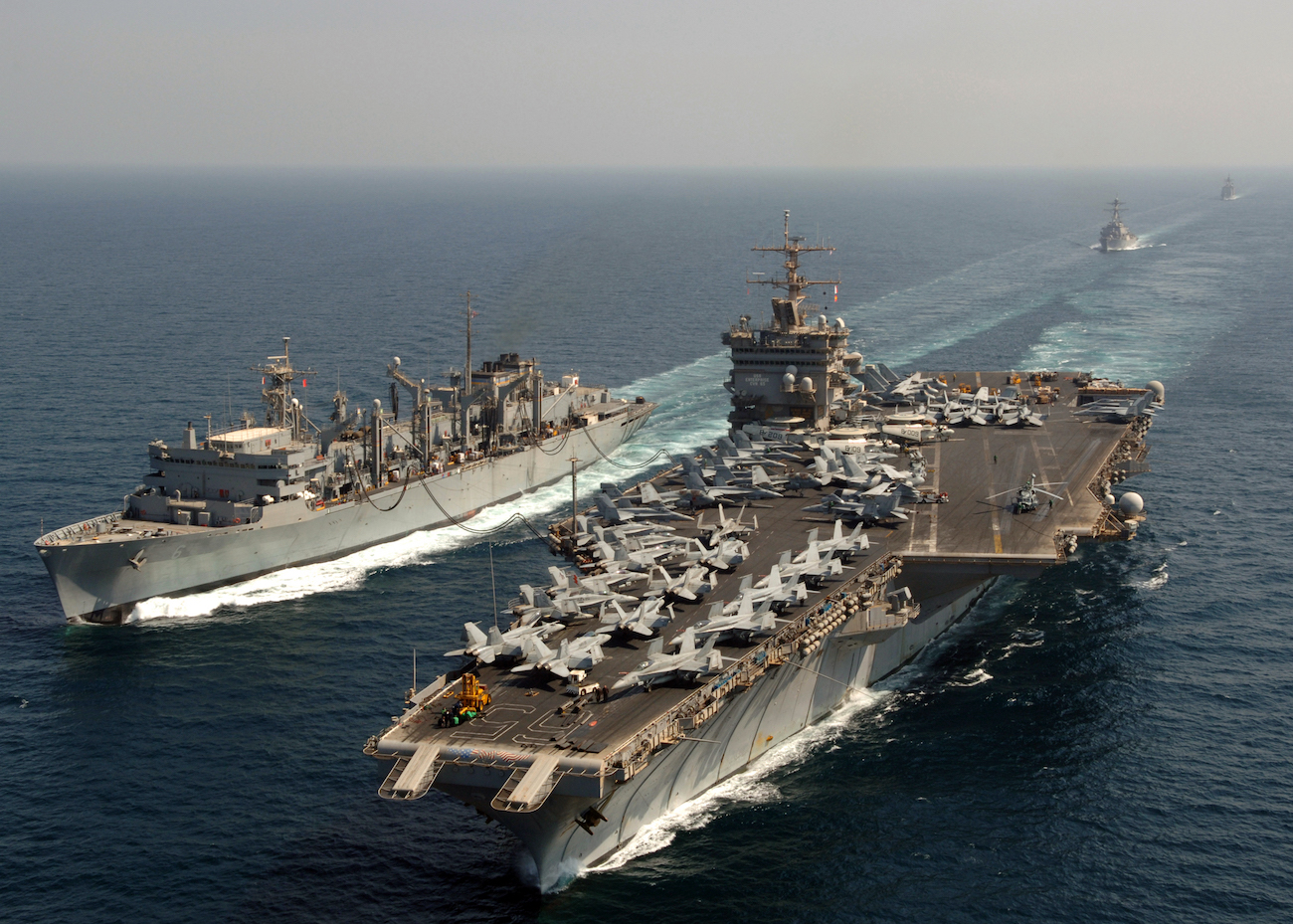 The nuclear-powered aircraft carrier USS Enterprise (CVN-65), conducts an underway replenishment with the Military Sealift Command fast combat support ship USNS Supply (T-AOE 6).
