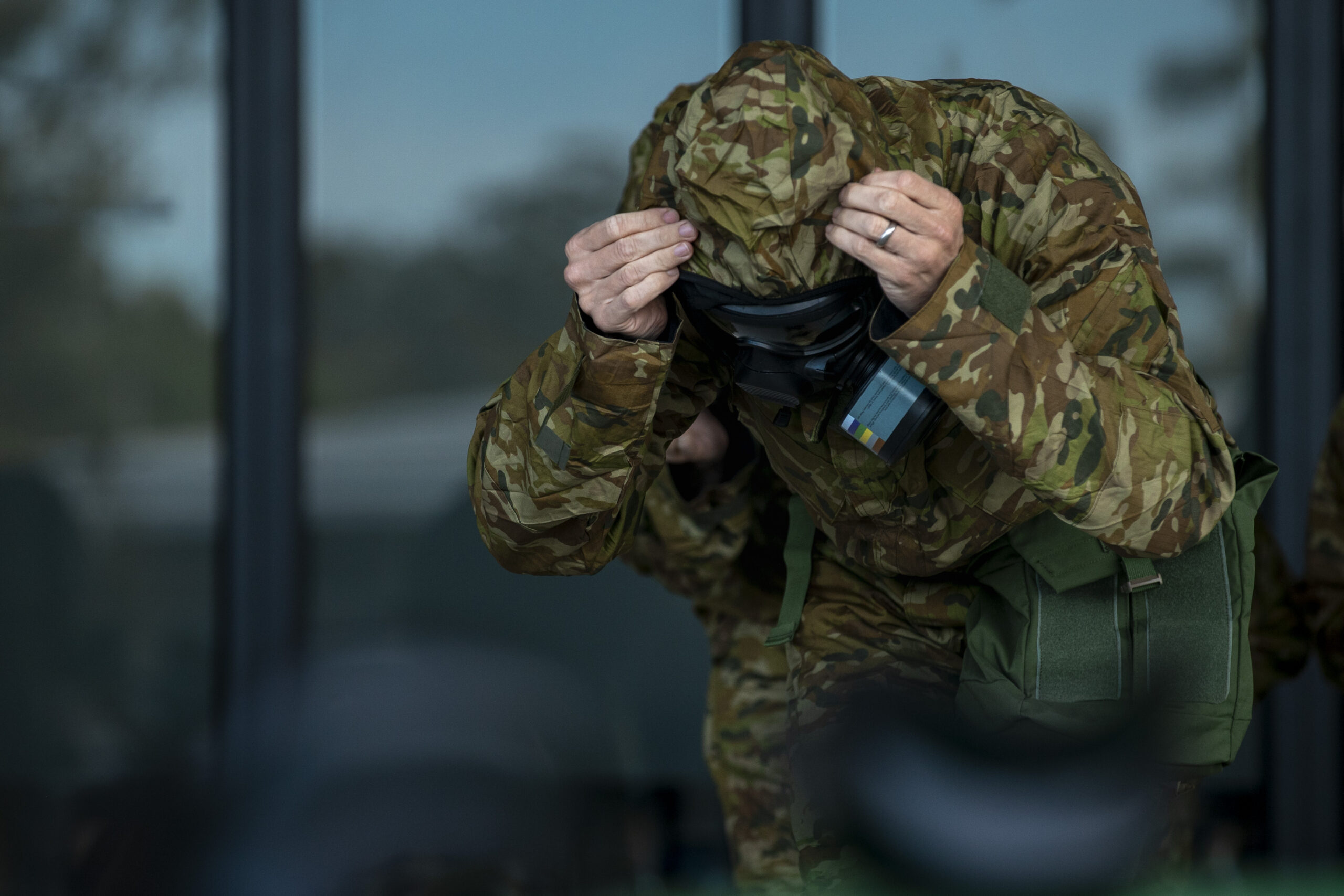 Australian Army soldiers from the 8th/9th Battalion, The Royal Australian Battalion put on their masks during a Chemical, Biological, Radiological, Nuclear Defence (CBRN-D) training serial at Gallipoli Barracks, Queensland. *** Local Caption *** Soldiers from 8th/9th Battalion, The Royal Australian Regiment, conducted chemical, biological, radiological and nuclear defence (CBRN-D) training in April at Gallipoli Barracks, Brisbane. Members were educated about what to do in a location with a CBRN-D threat, and how to rapidly apply personal protective equipment. They were also trained on how to treat a casualty in that environment and evacuate them from the area.