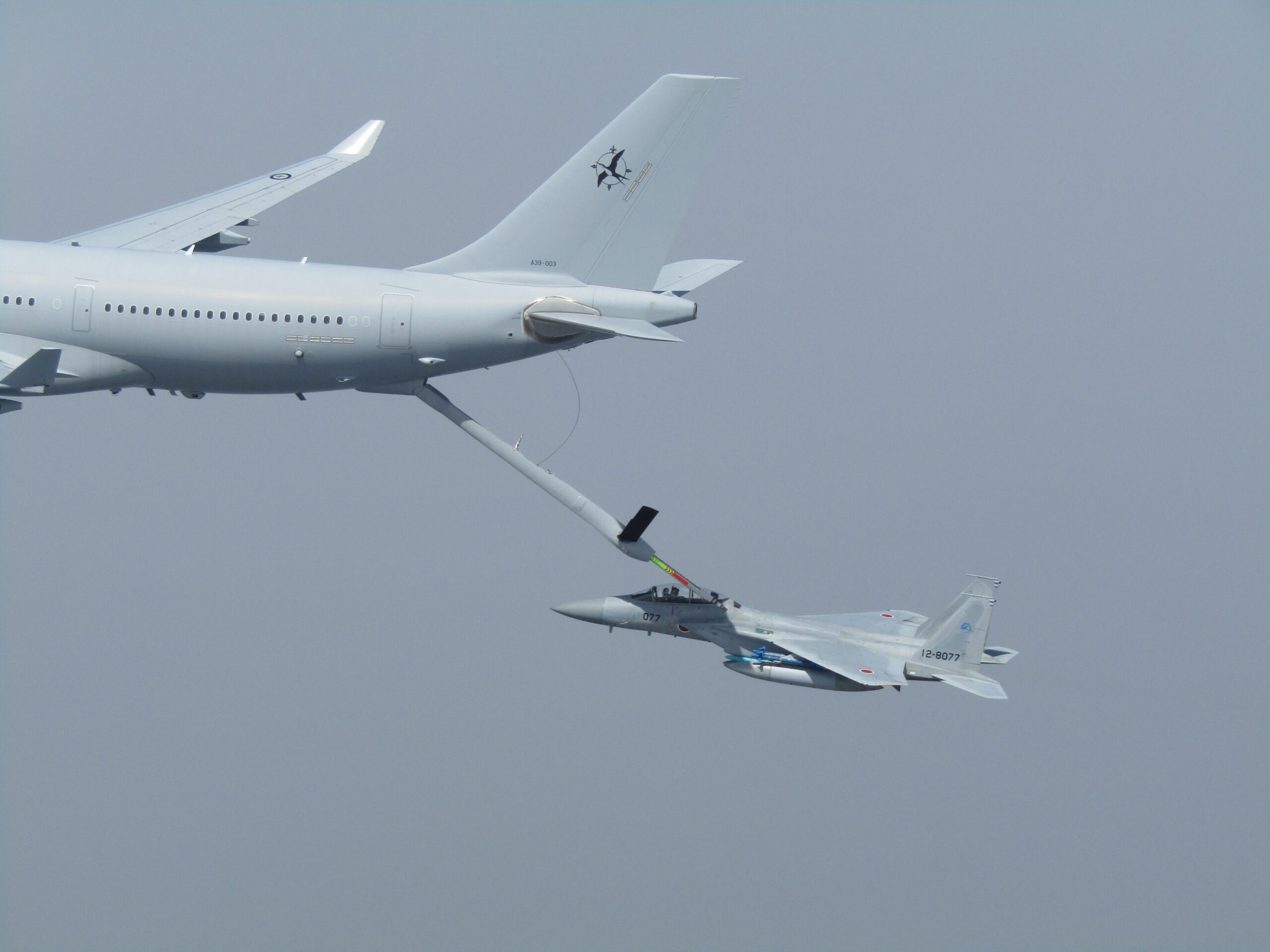 Royal Australian Air Force (RAAF) KC-30A Multi-Role Tanker Transport conducting refuelling trials with Japan Air Self-Defense Force (JASDF) F-15DJ Eagle. *** Local Caption *** From March 29 to April 26, a Royal Australian Air Force (RAAF) KC-30A Multi-Role Tanker Transport (MRTT) successfully completed air-to-air refuelling trials with Japan Air Self-Defense Force (JASDF) F-15J and F-15DJ jets for the first time. The trials involved the KC-30A using its Advanced Refuelling Boom to connect with the F-15s in flight. A total of 11 flights and 325 contacts were conducted with the aircraft flying a range of manoeuvres, and in different conditions by day and night. The engineering data from these trials will allow the RAAF to authorise and train its KC-30A aircrew to refuel F-15s in future. Air-to-air refuelling extends the range and endurance of a receiver aircraft, allowing them to conduct missions over a greater distance, carry heavier payloads, or spend more time within an airspace. The RAAF operates a fleet of seven KC-30A MRTTs from RAAF Base Amberley, west of Brisbane, with each aircraft able to carry more than 100 tonnes of fuel and transfer part of that load to a receiver aircraft. Since their introduction to service in 2011, RAAF KC-30As have been used extensively in support of refuelling Australian and foreign aircraft alike.