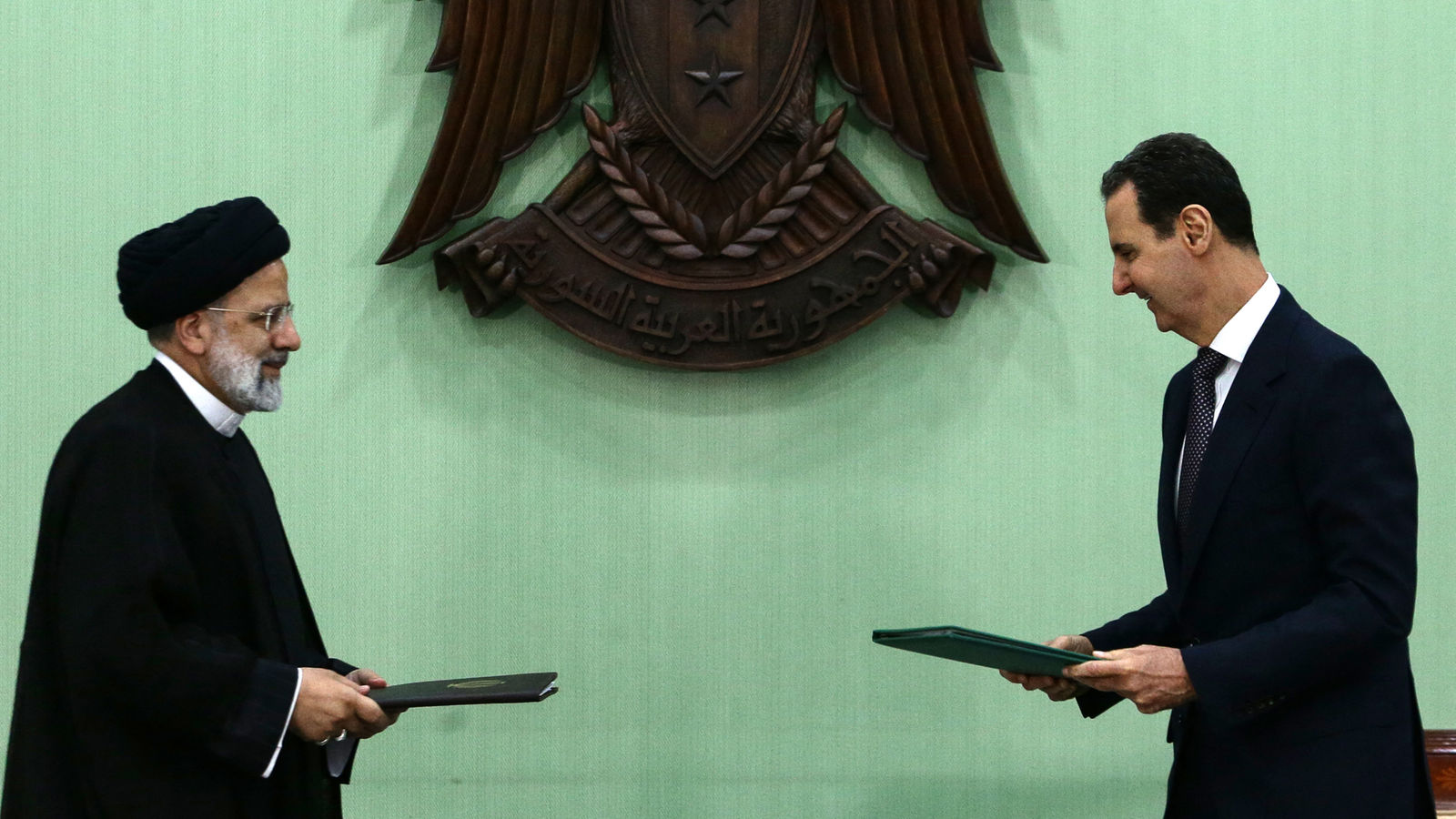 Syria's President Bashar al-Assad (R) and his Iranian counterpart Ebrahim Raisi
