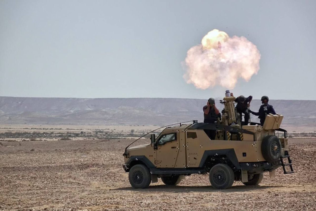 Live firing of 120-mm mortar mounted on armored vehicle.