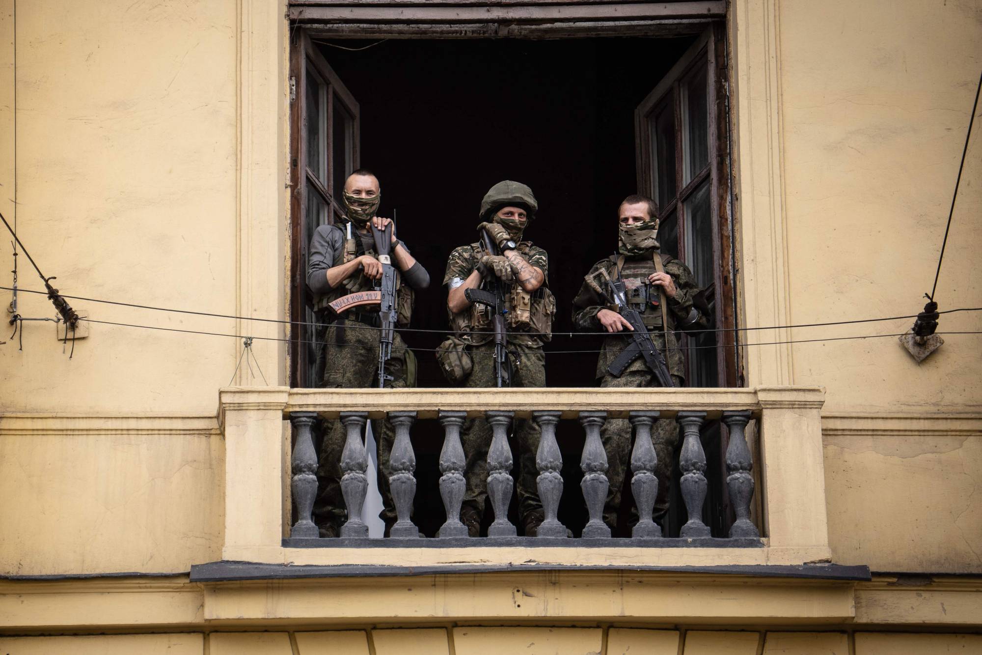 Members of Wagner group stand on the balcony of the circus building in the Russian city of Rostov-on-Don
