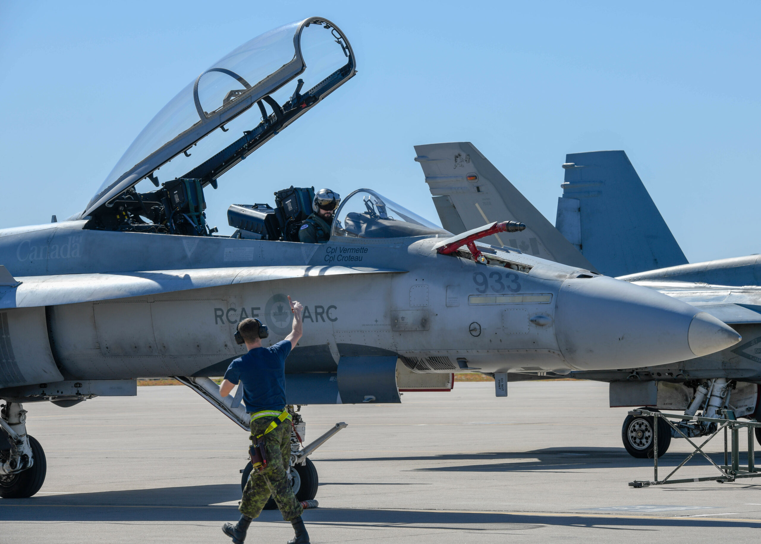 A Royal Canadian air force crew chief, assigned to the 433rd Tactical Fighter Squadron in Canadian Forces Base Bagotville, Quebec, Canada, gives a CF-18 Hornet pilot a thumbs up Feb. 25, 2020, at Luke Air Force Base, Ariz. While at Luke, 140 RCAF personnel and 12 aircraft participated in the Tipic Sauvage and Haboob Havoc exercises and conducted training with the U.S. Air Force. Luke regularly hosts exercises and competitions for pilots to hone their skills in air-to-air and air-to-ground contests as well as build camaraderie. (U.S. Air Force photo by Airman 1st Class Brooke Moeder)