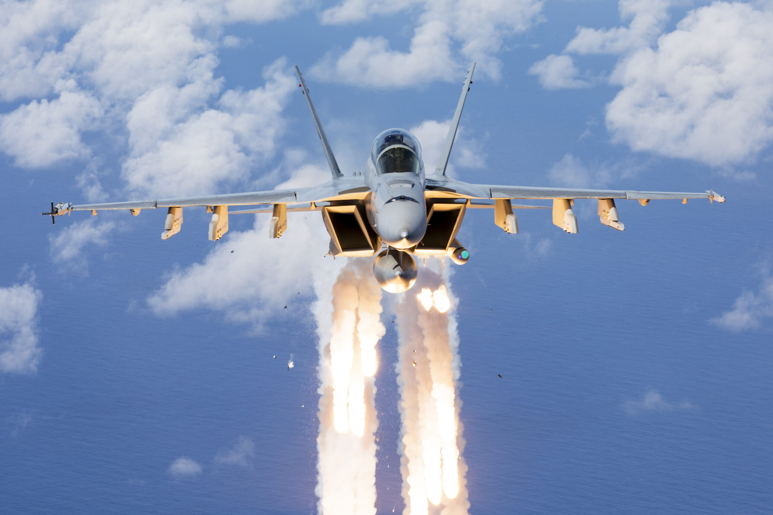 Royal Australian Air Force F/A-18F Super Hornet A44-216 from No. 1 Squadron deploys flares while conducting air-to-air formation flying off the coast of South East Queensland. *** Local Caption *** On 07 December 2021, No. 6, No. 1 and No. 36 Squadrons from RAAF Base Amberley conducted a formation flying activity with EA-18G Growlers, F/A-18F Super Hornets and a C-17A Globemaster III Aircraft off the coast of South East Queensland.