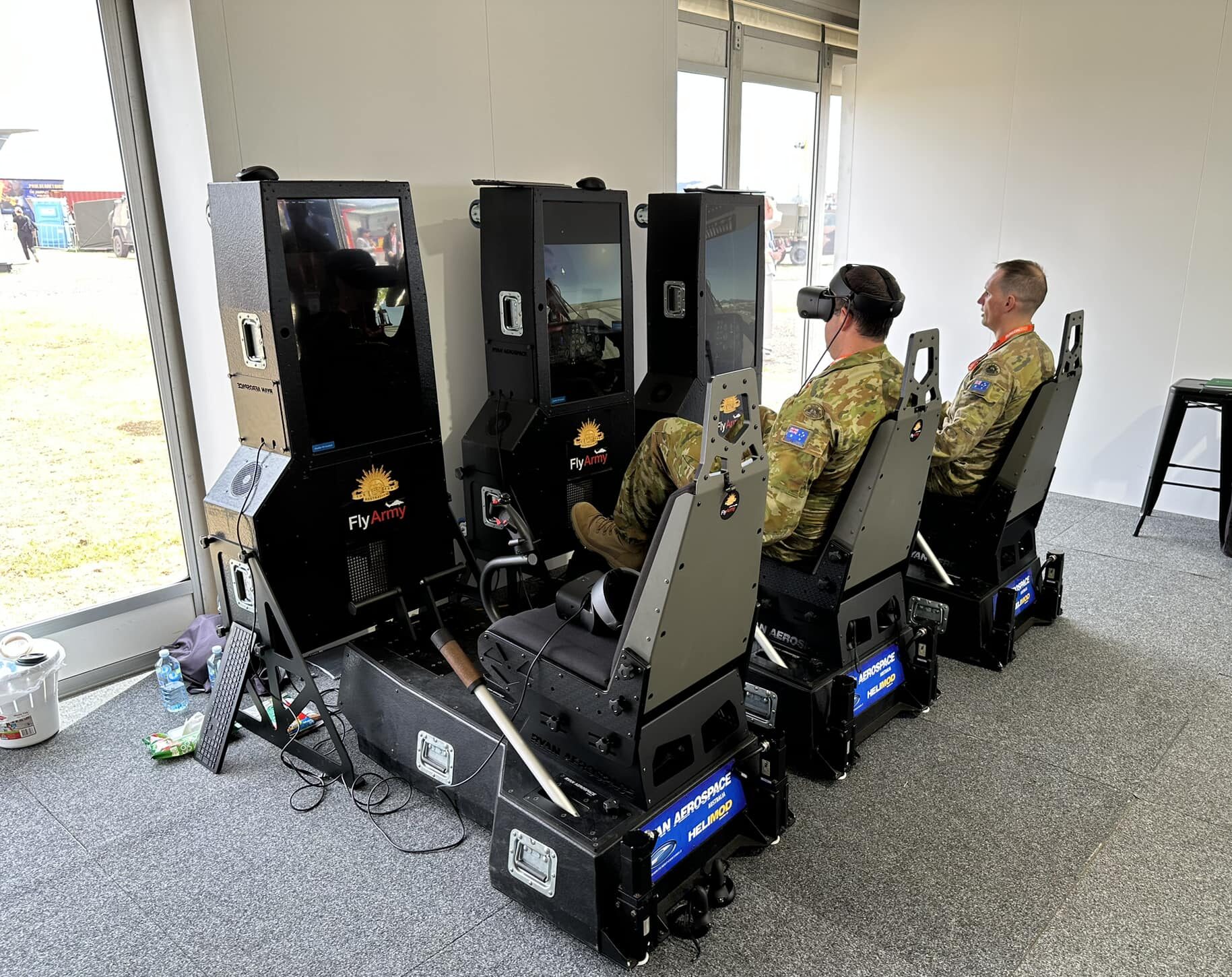 Army officers test out Ryan Aerospace's virtual reality flight simulators at the Australian International Airshow.