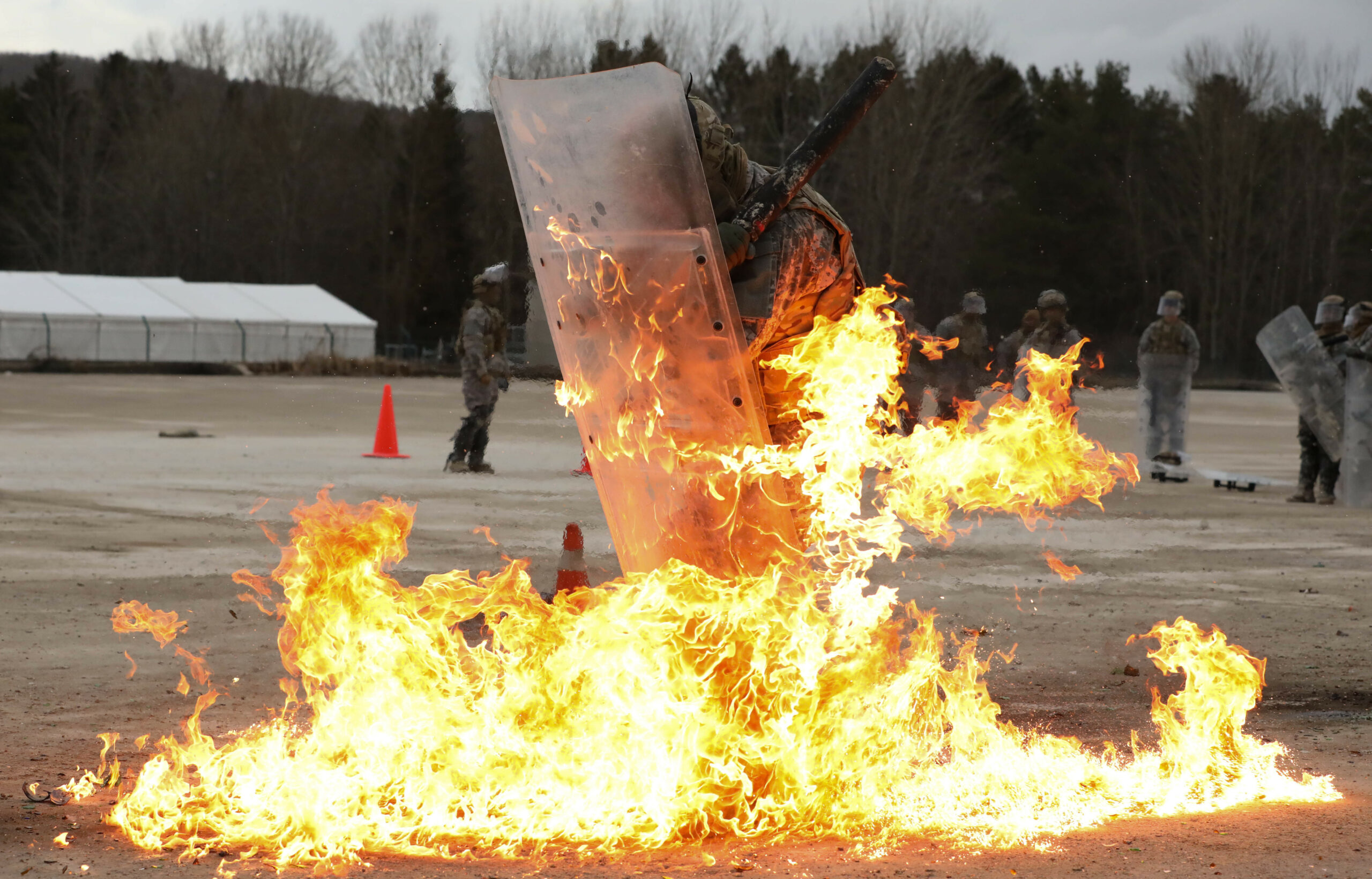 Soldiers with the 1st Battalion, 149th Infantry, Charlie Company conduct fire phobia Crowd Riot Control training (CRC) from their Slovenian instructors at the Joint Multinational Readiness Center (JMRC) in Hohenfels, Germany Feb. 11, 2022. Fire phobia training is meant to familiarize Soldiers with response to an improvised incindiery device, Molotov cocktail, in a riot control situation. (U.S. Army National Guard photo by Spc. Alexander Hellmann)