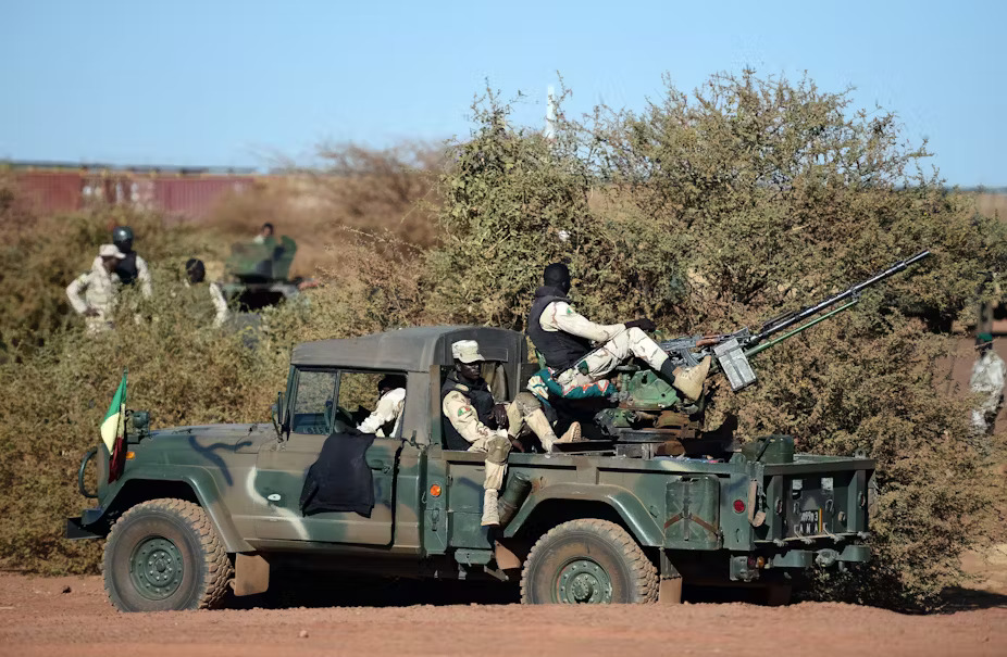 Armed and Security Forces of Mali servicemen stand guard on a military vehicle