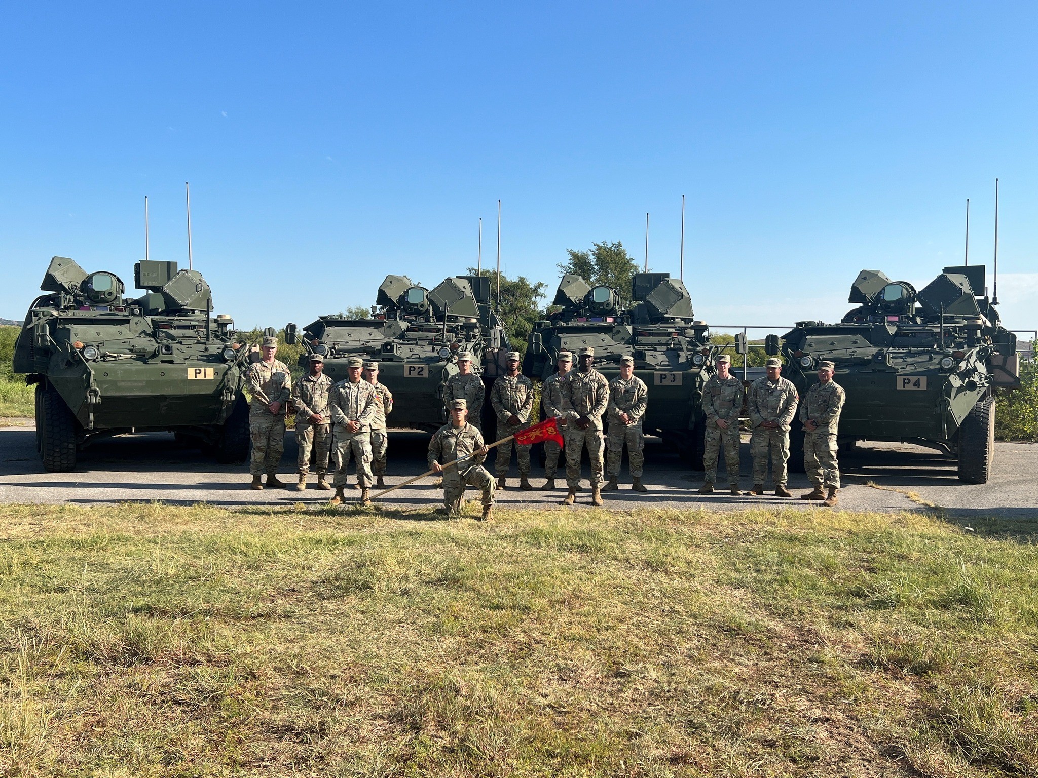 Soldiers of the 4th Battalion, 60th Air Defense Artillery Regiment are positioned alongside four Directed Energy Maneuver-Short Range Air Defense (DE M-SHORAD) prototype systems. (4th Battalion, 60th Air Defense Artillery Regiment )