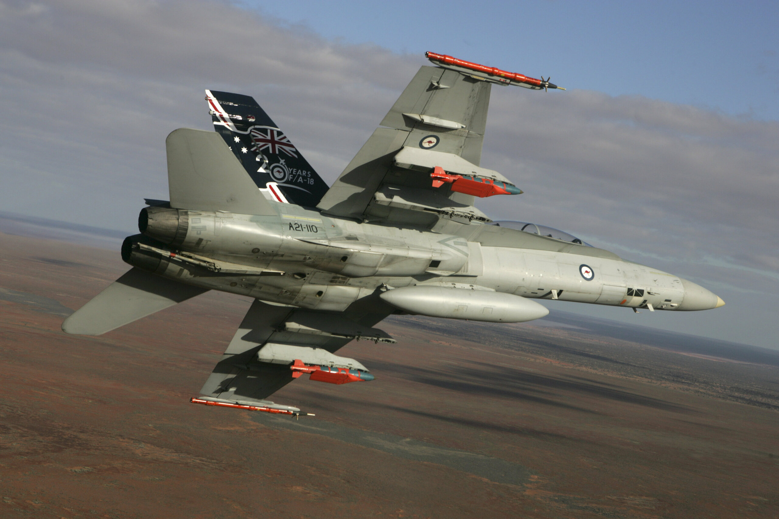A Royal Australian Air Force F/A-18 Hornet in flight with two JDAM-ER 500lb bombs and two Time Space Position Information pods. Deep cap: TESTS OF EXTENDED RANGE 'SMART' BOMBS The Department of Defence, in conjunction with Hawker de Havilland and The Boeing Company, has conducted the successful initial testing of an extended range Joint Direct Attack Munition (JDAM) variant. The successful tests were conducted at Woomera, South Australia, in mid August. The development activity was conducted under the Concept Technology Demonstrator (CTD) Program managed by the Defence Science and Technology Organisation (DSTO). The Joint Direct Attack Munition Extended Range (JDAM-ER) is a conventional JDAM, enhanced with an Australian designed wing kit which has the potential to significantly increase its range. The wing kit was developed by Hawker de Havilland, based on technology licensed from DSTO.