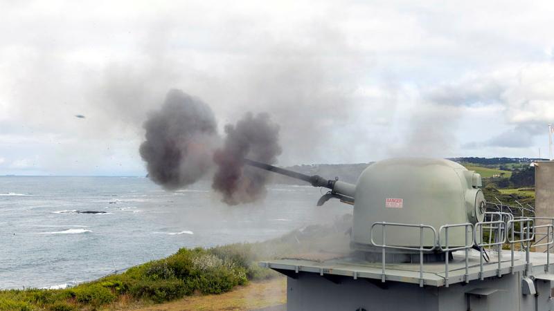 The 76mm medium caliber gun (MCG) installed at West Head gunnery range in Flinders, Victoria is seen firing a round of ammunition towards the sea.