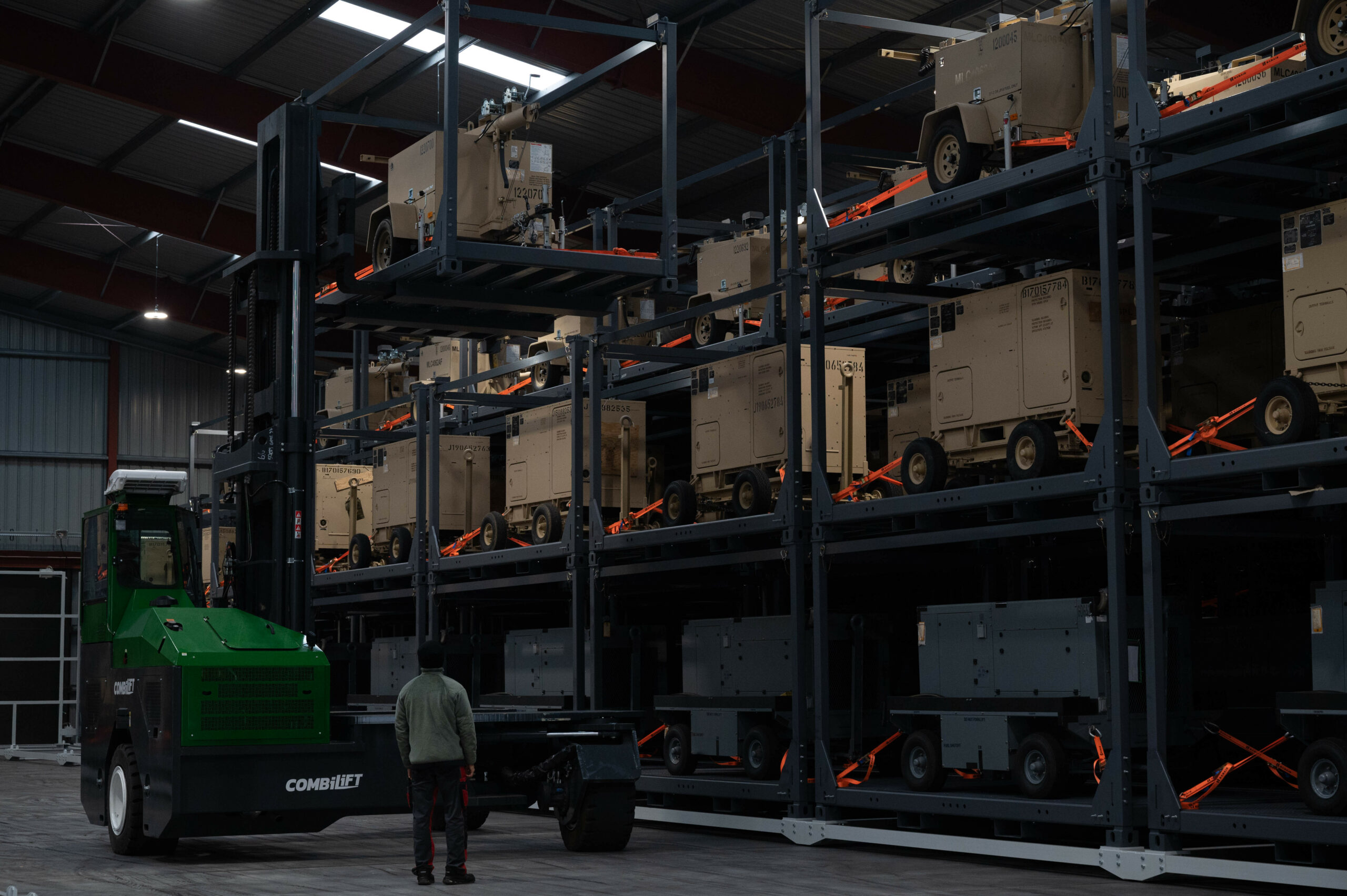 Members of the Warehouses Service Agency operate a forklift to deliver a generator to its holding area at the Central Region Storage Facility in Sanem, Luxembourg, Oct. 12, 2021. During Afghanistan evacuation operations, the CRSF and Warehouses Services Agency volunteered to go into 24/7 operations for the first time in 10 years to support Operation Allies Welcome. (U.S. Air Force photo by Senior Airman Taylor Slater)