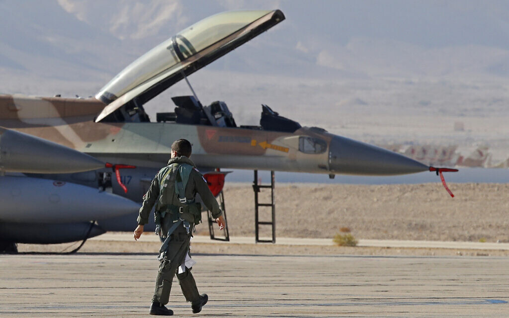 An Israeli Air Force pilot walks to his F-16 fighter jet during the 