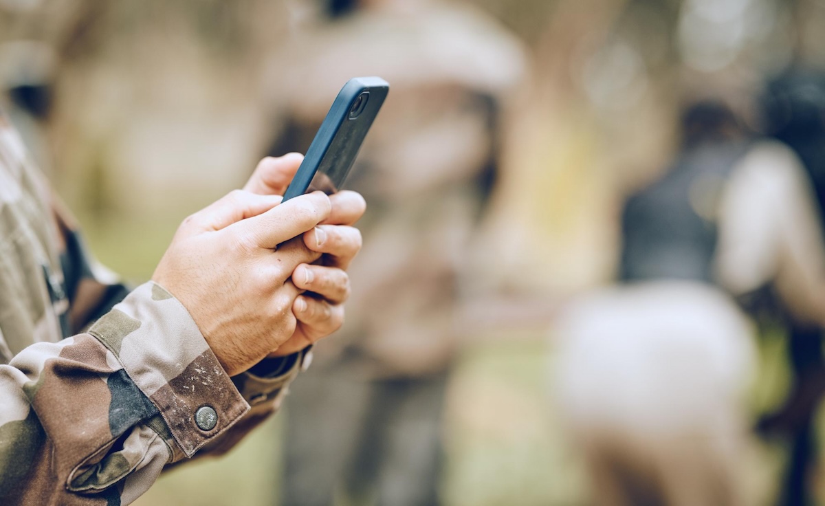 Soldier holding phone in his hand