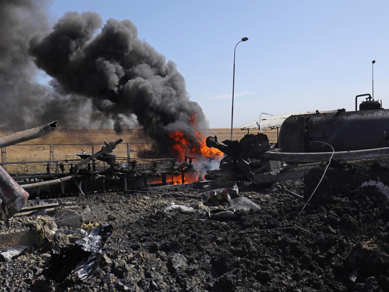 Smoke billows from the Babasi oil facility in the countryside of al-Qahtaniya in Syria's Kurdish-controlled northeastern Hasakeh province on October 6, 2023 following a Turkish strike