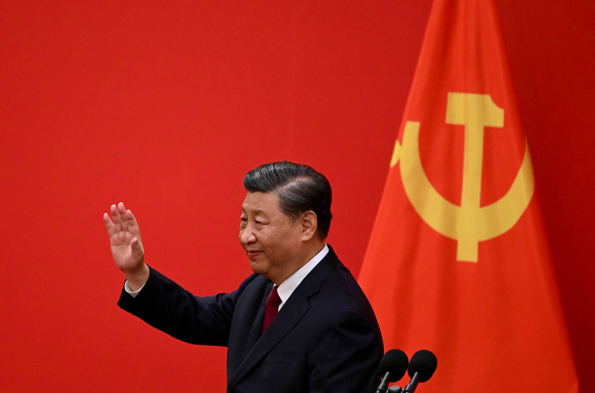 China's President Xi Jinping waves after introducing the members of the Chinese Communist Party's new Politburo Standing Committee, 2022