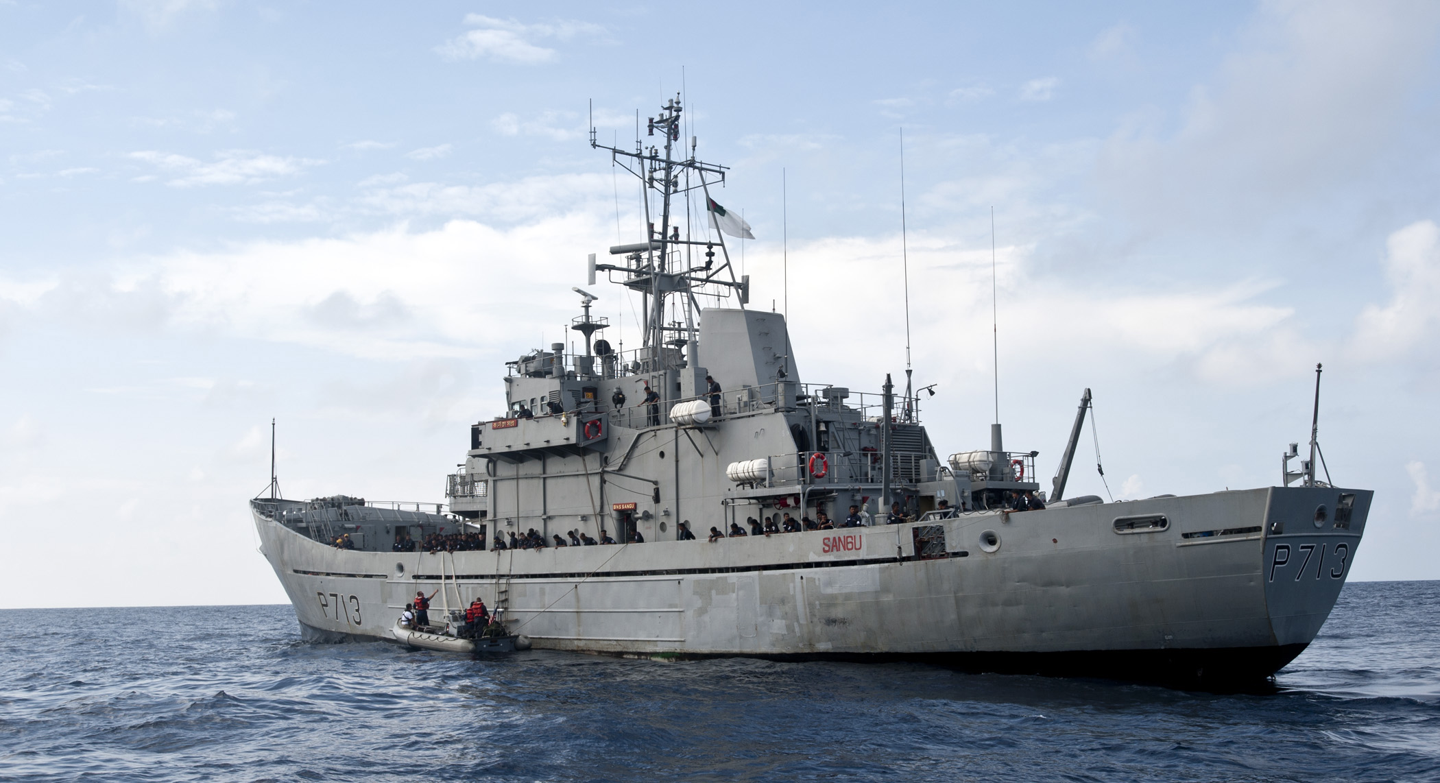 The Bangladesh Navy Ship Sangu (P-713) sails on the water. The ship is painted grey and it has 