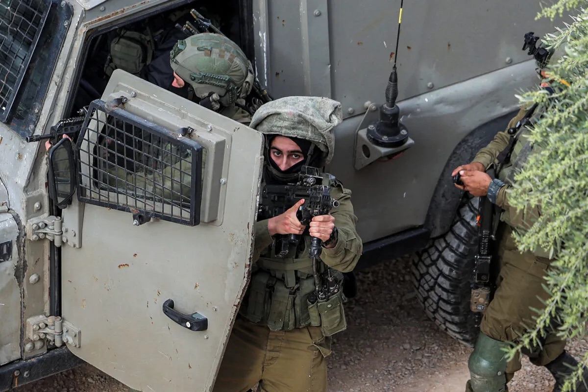 Israeli army soldier looks on during a military operation