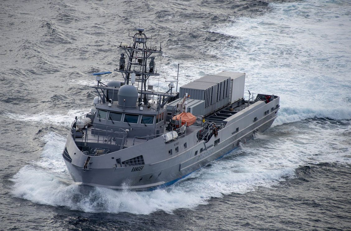 Ranger, a US Navy unmanned surface vessel, is seen sailing blue-grey waters. Its hull is painted black and the word 