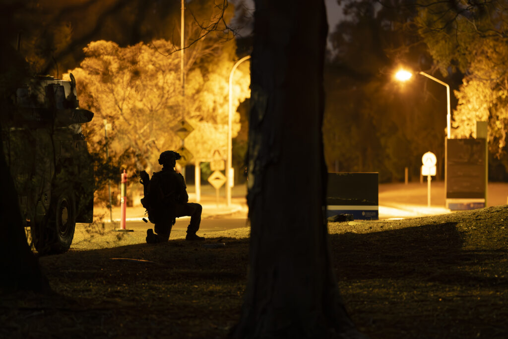 An Australian Army soldier from Charlie Company, 1st Battalion, The Royal Australian Regiment provides security during an urban clearance on Exercise Green Blaze at James Cook University, Townsville, Queensland. *** Local Caption *** Australian Army soldiers from Charlie Company, 1st Battalion, The Royal Australian Regiment conducted live-fire combat shooting serials, full mission profiles and air mobility operations as part of Exercise Green Blaze from 23 Oct  24 Nov 2023 at Lavarack Barracks and Mount Stuart Training Area, Townsville, Queensland.