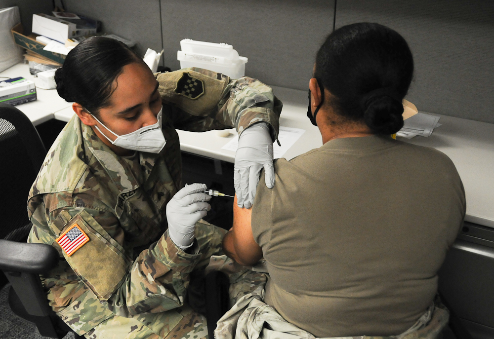 Master Sgt. Daniela Davis, right, receives a flu shot from Sgt. Veronica Ygarza as part of the 99th Readiness Division’s in-house flu clinic for the 2020-2021 flu season. The flu-shot program is being administered by the division’s Surgeon’s Office and Soldier Readiness Improvement Program team. Three-hundred vaccinations are being provided to 99th RD Soldiers and civilian employees during normal duty hours and Battle Assembly weekends. (U.S. Army photo by Mr. Sal Ottaviano)