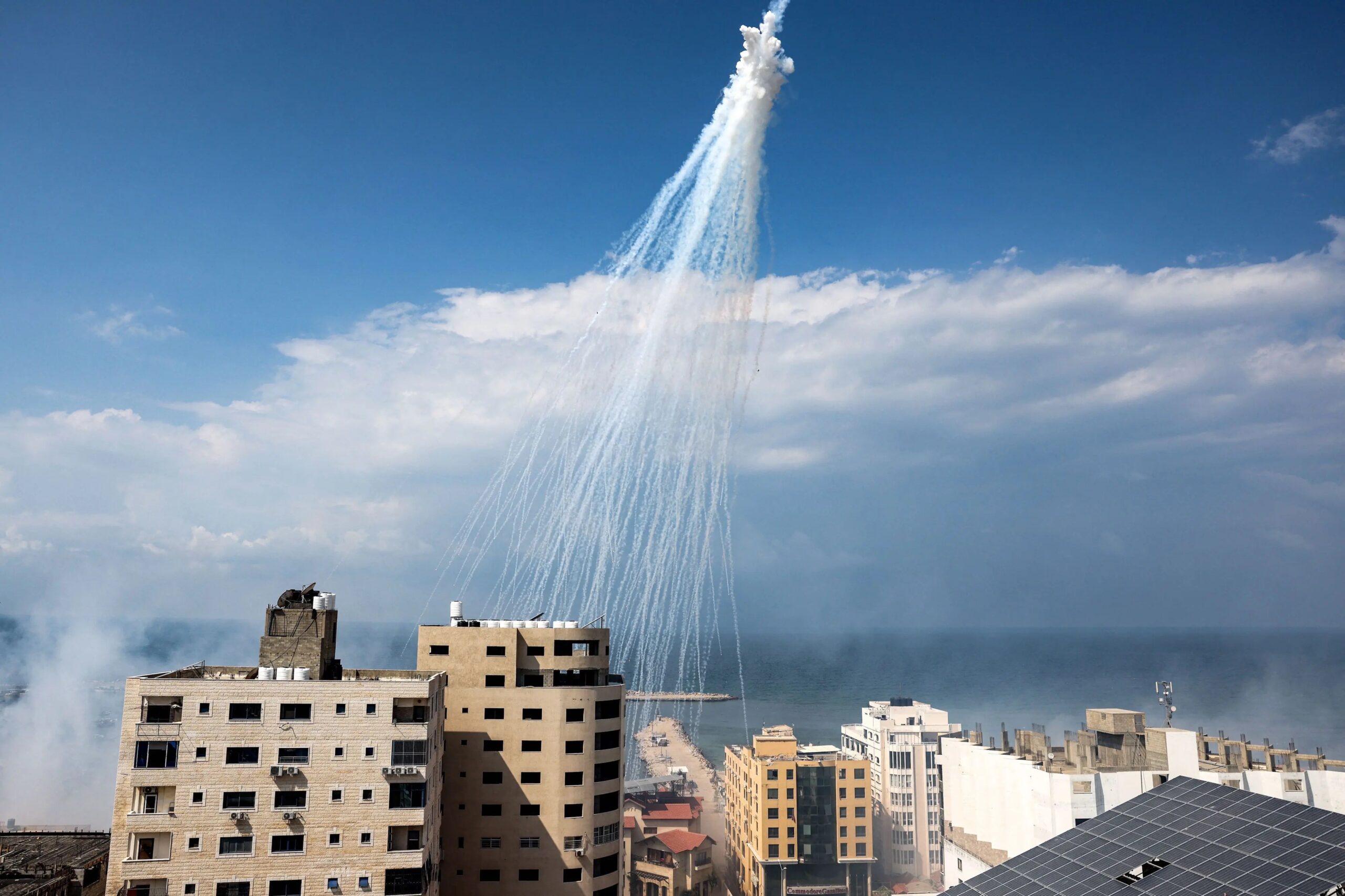 Airbursts of artillery-fired white phosphorus fall over the Gaza city port, October 11, 2023