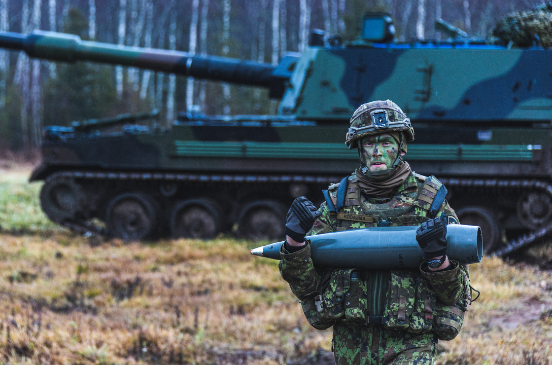 Soldier holding artillery ammunition