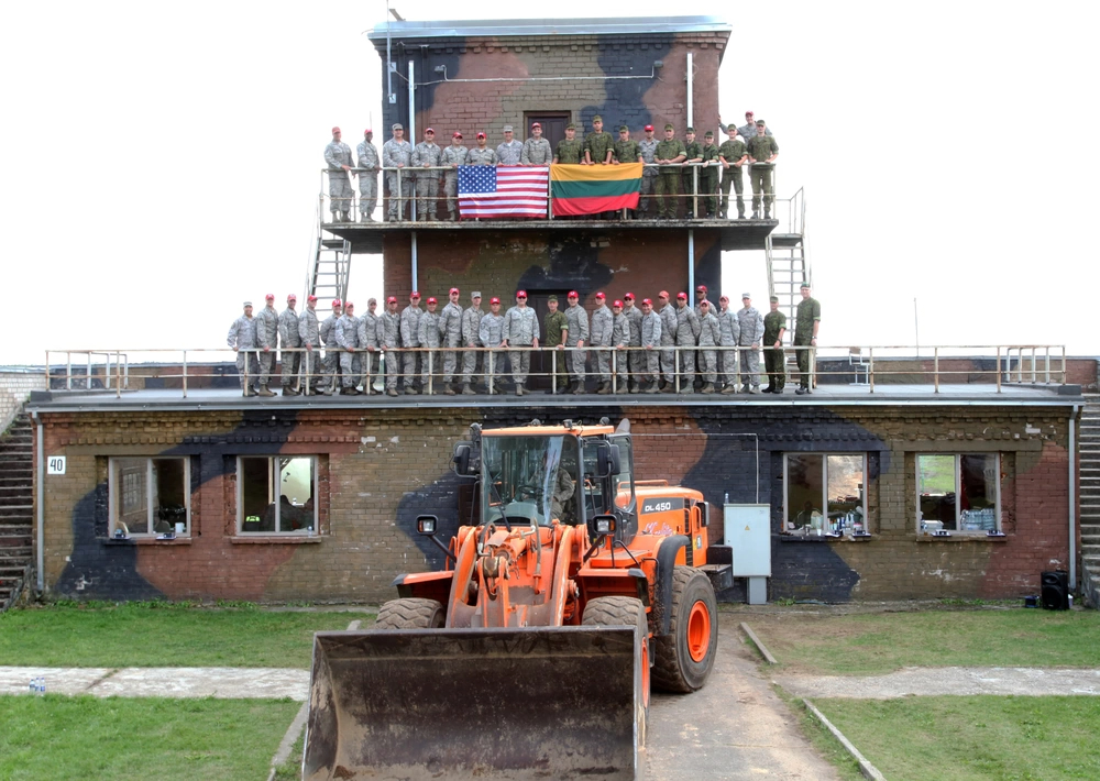 Members of the 201st RED HORSE (Rapid Engineer Deployable Heavy Operational Repair Squadron Engineers), 201st RHS DET 1 and 271st Combat Communications Squadron, along with their Lithuanian counterparts, pose for a final picture Aug. 27, 2018, before the departure of the Rotation 3 team. Four teams of Airmen, which include primarily Pennsylvania Air National Guard civil engineer personnel, have been working to construct a military air-to-ground training range at the Brigadier General Kazio Veverskis Training Grounds in Kazlu Ruda, Lithuania. They broke ground on the project July 8, 2018, with completion slated for mid-September. The range is designed to provide Lithuanian and other NATO forces with realistic troop training, similar to what the Pennsylvania National Guard's Bollen Air-To-Ground Weapons Range provides stateside.