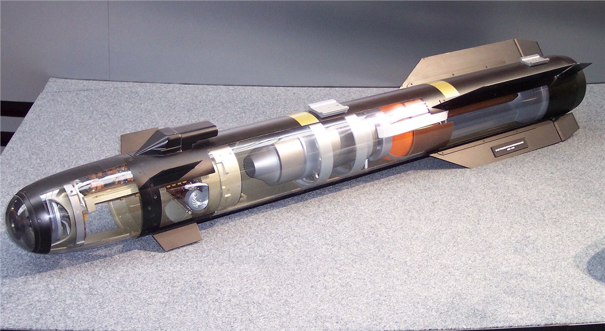A model of a Hellfire AGM-114R2 missile is seen on display. Parts of its body is transparent, showcasing its inner parts and mechanisms.