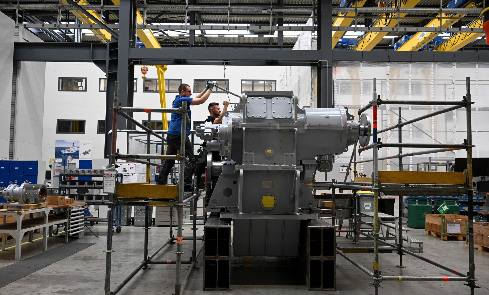 Employees work at a ship gear at a Renk facility in Augsburg, Germany