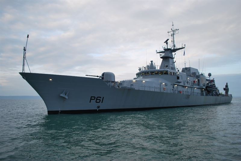 An Irish Naval Service's offshore patrol vehicle, LÉ Samuel Beckett (P61), is seen sailing calm, green-blue waters. The gray ship has 
