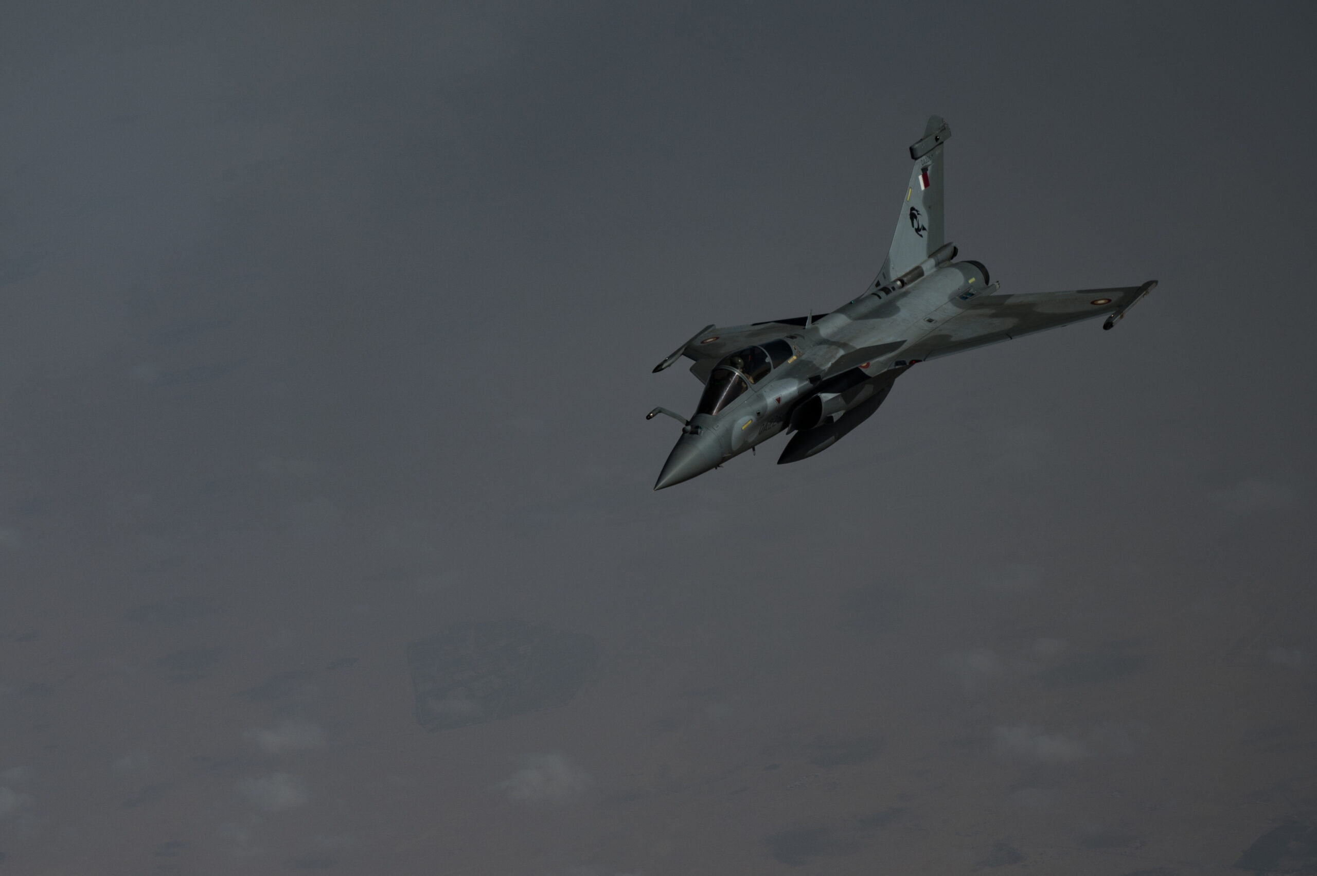 A Qatar Emiri Air Force Rafale fighter aircraft flies above Qatar, after receives fuel from a U.S. Air Force KC-135 Stratotanker Dec. 31, 2020. This event built familiarity with the air-to-air refueling process with both air forces. (U.S. Air Force photo by Staff Sgt. Sean Carnes)