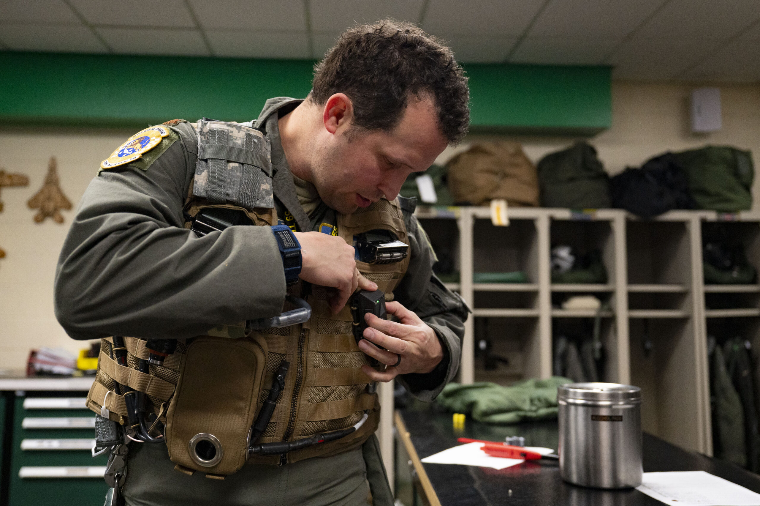 U.S. Air Force Lt. Col. Joshua Arnall, director of operations, 59th Test and Evaluation Squadron, adjusts the Integrated Cockpit Sensing, or ICS, system prior to flight testing at Nellis Air Force Base, Nevada, Jan. 30, 2024. An Air Force Research Laboratory team developed the ICS system to provide an airworthy platform for comprehensive physiological, life-support and environmental monitoring to improve pilot safety and performance. (U.S. Air Force photo / Senior Airman Megan Estrada)