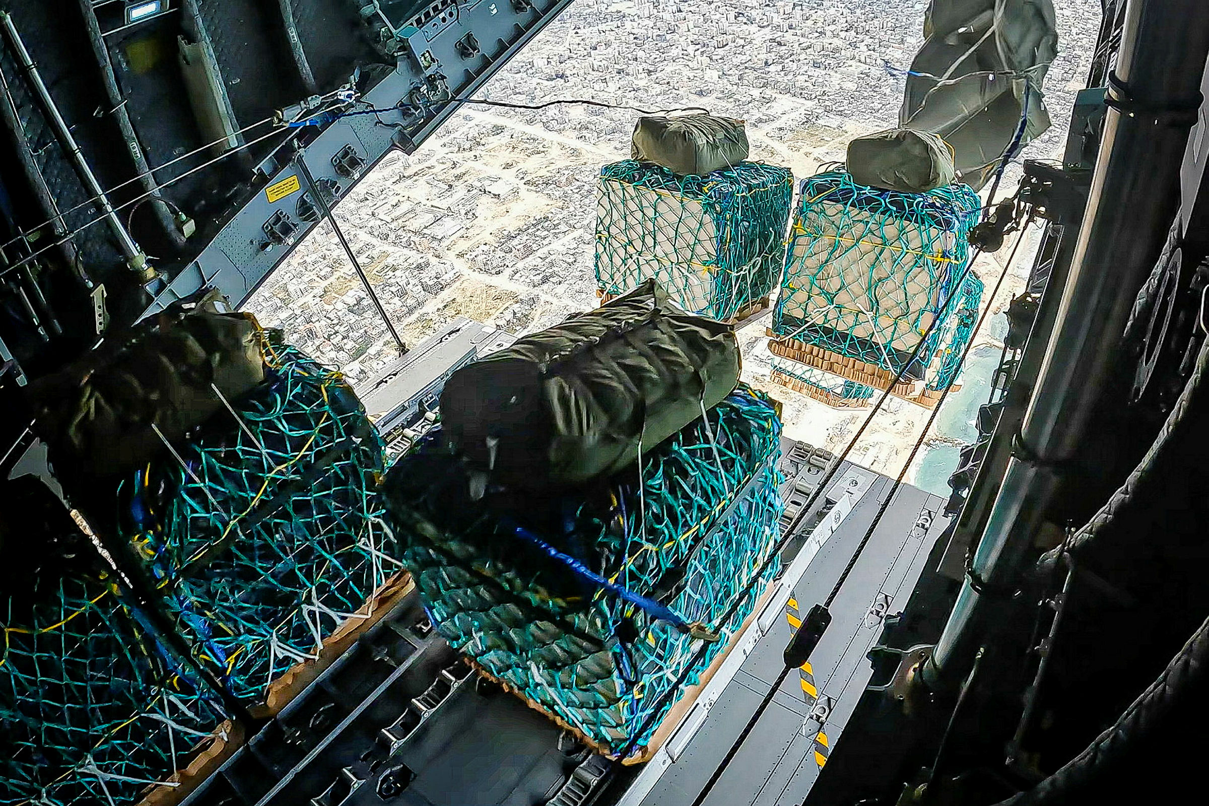 Image of humanitarian aid, seen here being airdropped over Gaza from a RAF A400M aircraft today (25/03/2024). The Royal Air Force airdropped over 10 tonnes of food supplies into Gaza for the first time on Monday, as part of international efforts to provide life-saving assistance to civilians. The aid, which consists of water, rice, cooking oil, flour, tinned goods and baby formula, will support the people of Gaza. The Defence Secretary authorised the airdrop following an assessed reduction in threat to the military mission and risk to civilians. An RAF A400M flew from Amman, Jordan to airdrop this aid along the northern coastline of Gaza, as part of the Jordanian-led international aid mission. UK personnel worked closely with the Royal Jordanian Air Force to plan and conduct this mission.