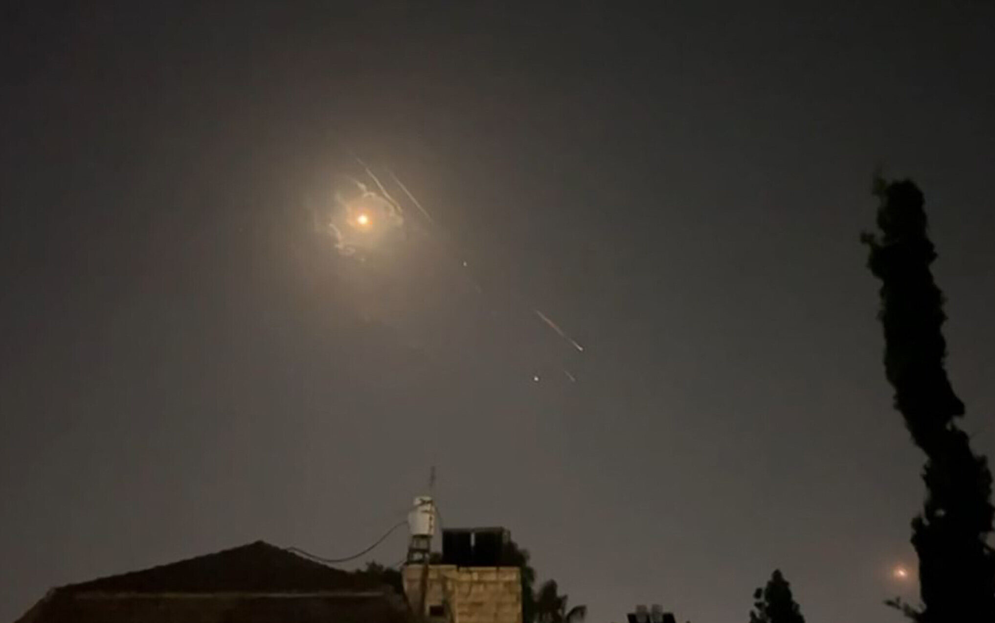 Explosions lighting up Jerusalem sky as Israeli air defenses respond to an Iranian attack on Israel