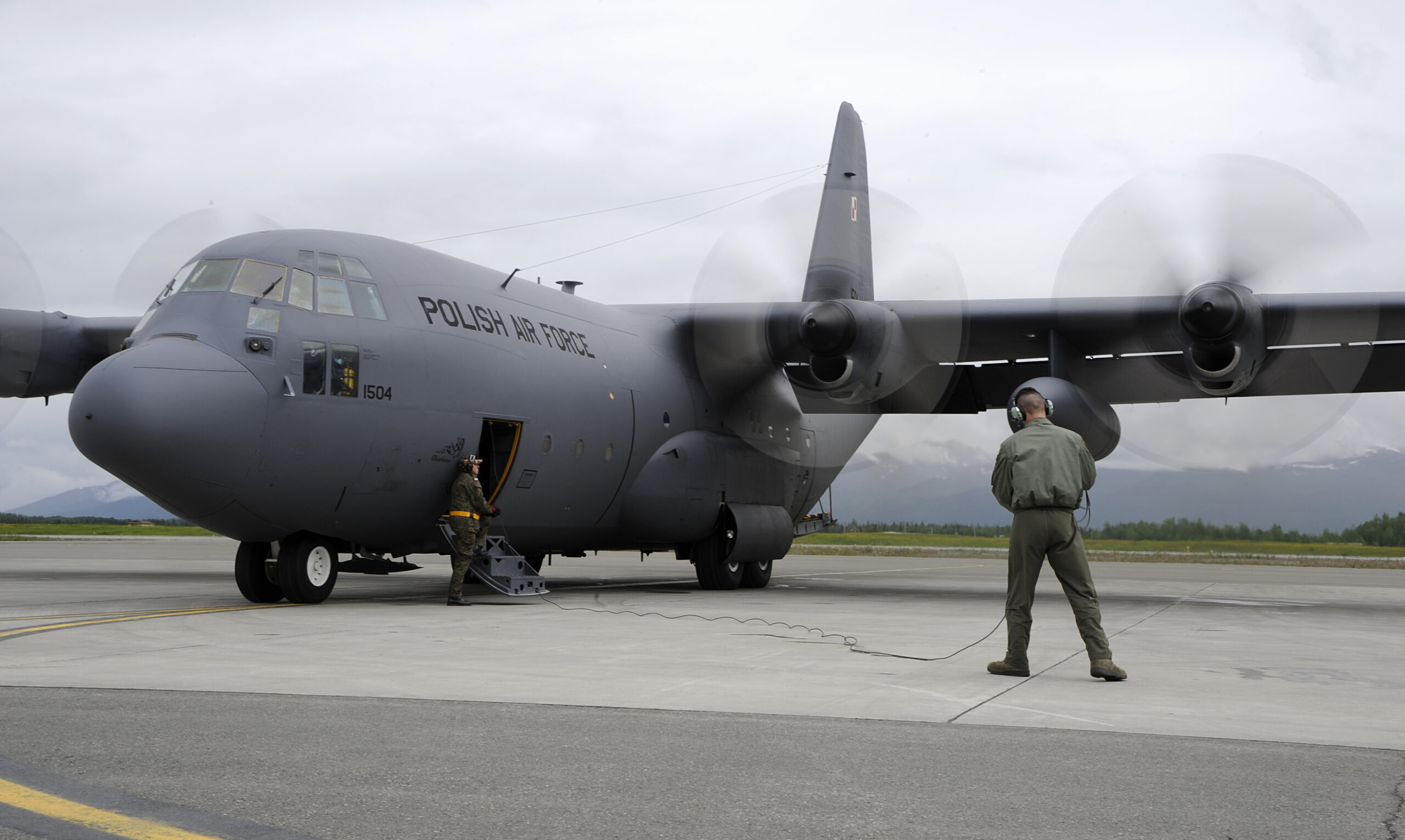 Members of the Polish air force C-130 Hercules maintenance crew ensure the propellers are working on the aircraft during Red Flag-Alaska on Joint Base Elmendorf-Richardson, Alaska, June 13, 2012. The goal of Red Flag-Alaska is to provide each aircrew with vital first missions to increase their chances of survival in combat environments.