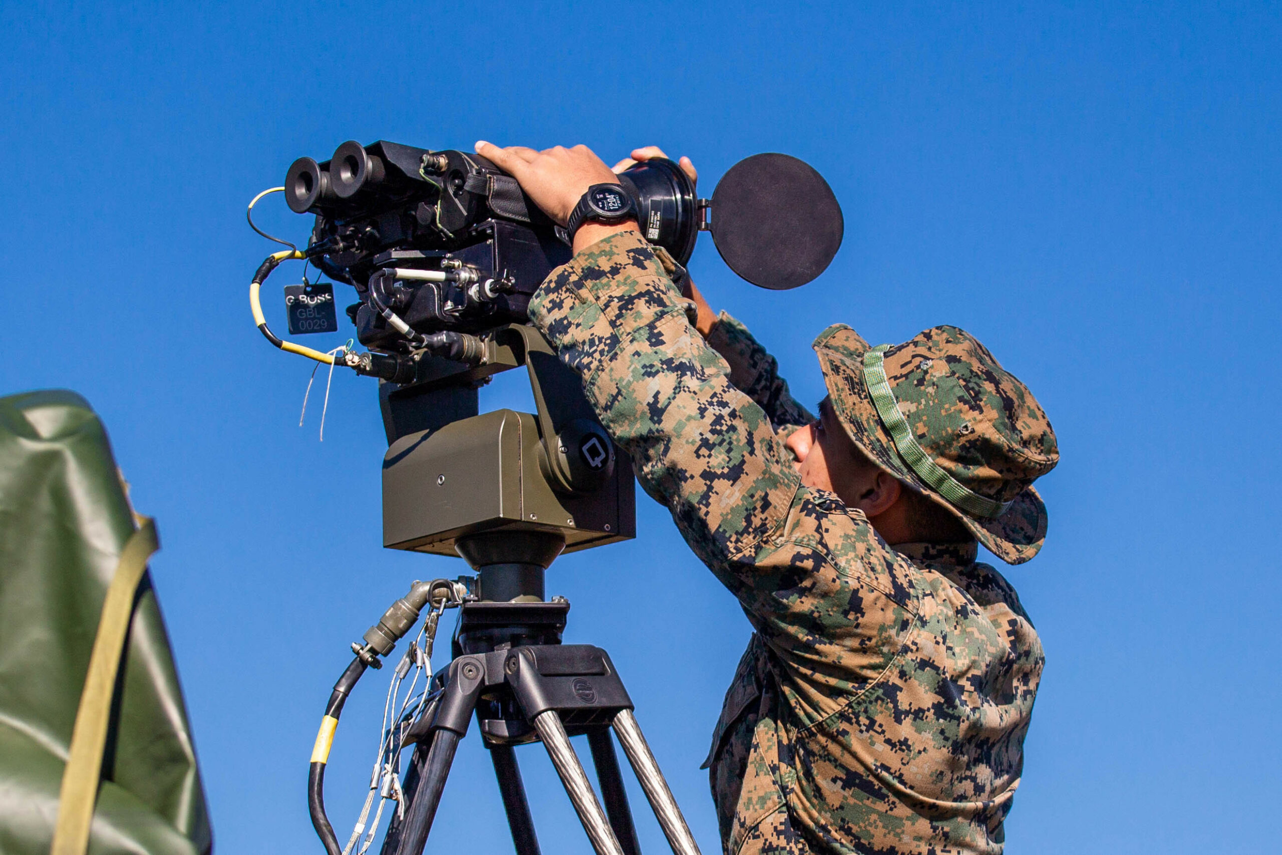 U.S. Marine Corps Lance Cpl. Andre Hernandez, a Surveillance Sensor Operator with 2nd Ground Support Platoon, Ground Surveillance Company, 2nd Intelligence Battalion, II Marine Expeditionary Force Information Group, operates the Ground Based Observational Surveillance System (GBOSS) at Marine Corps Auxiliary Landing Field Bogue, N.C., on Nov. 16, 2021. The GBOSS is used to detect and track movement in field environments. (U.S. Marine Corps photo by Cpl. Alexander Ransom)