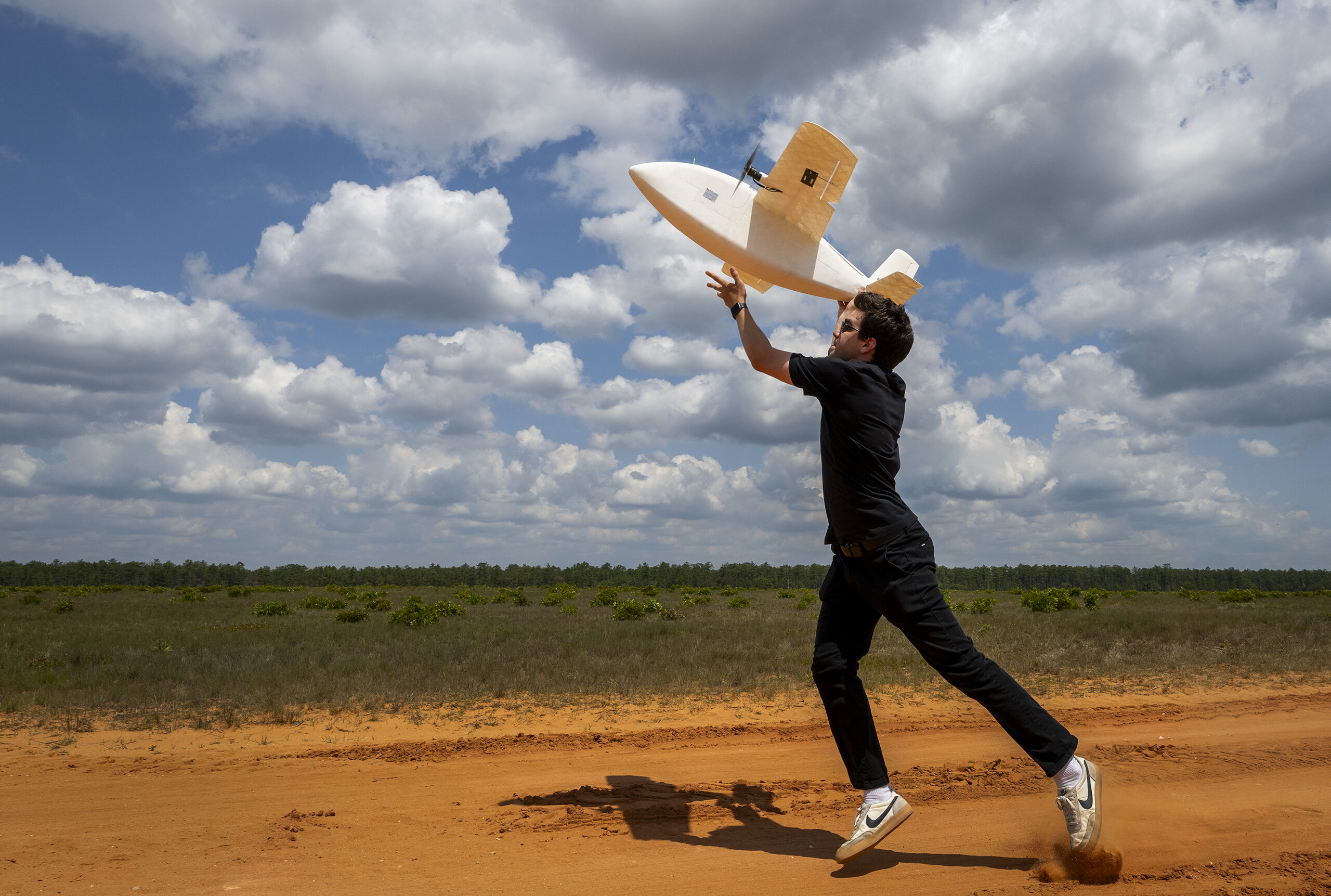 Noah Benton, Titan Dynamics chief technology officer, launches a an eight-pound, 3-D-printed unmanned aerial system during a Blue Horizons demonstration April 25, 2024 at Eglin Air Force Base, Florida. The goal of the demonstration was to create, build and fly a UAS within 24 hours. The team spent the week at Eglin creating UASs for various designs and mission specialties. (U.S. Air Force photo by Samuel King Jr.)