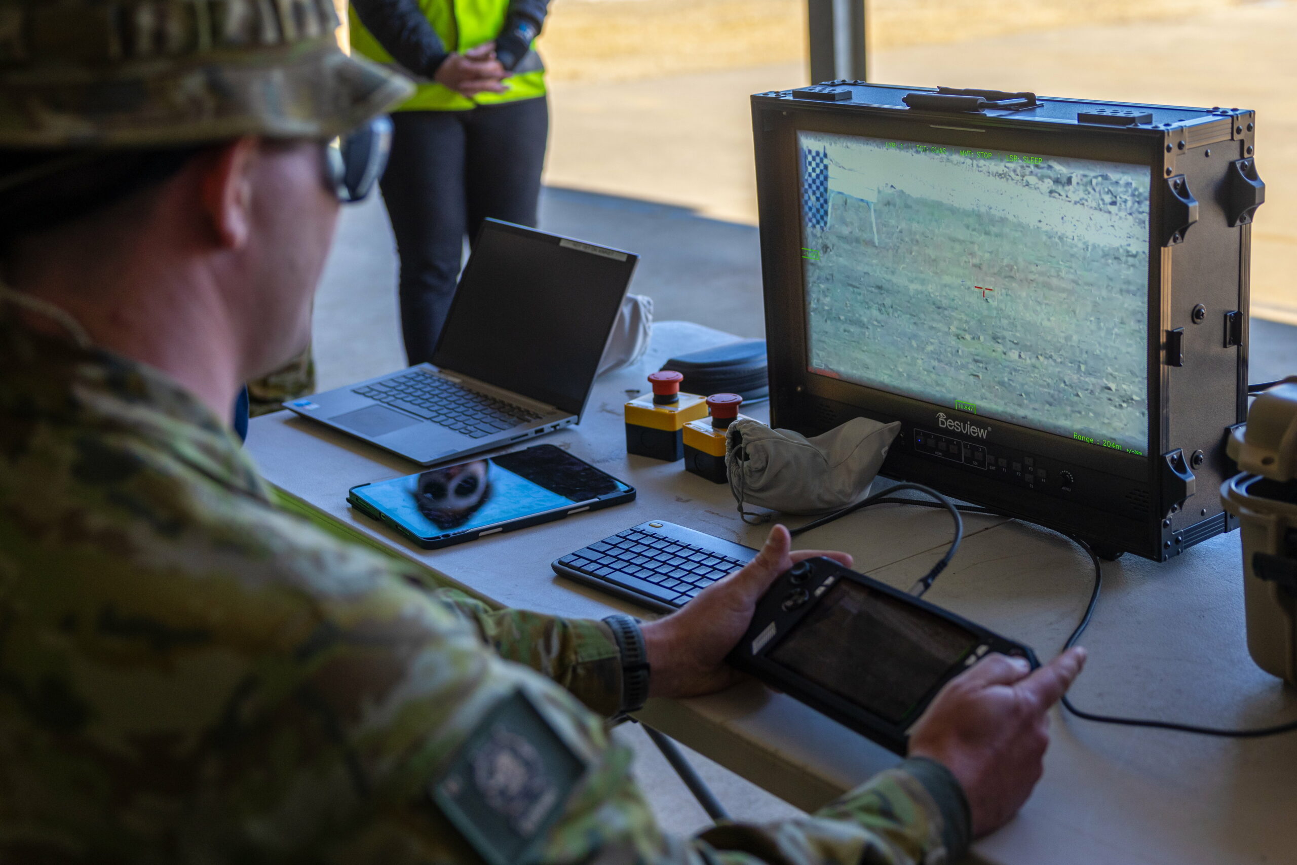 Australian Army Corporal Patrick Flanagan operates the AIM Defence Counter-UAS Directed Energy Weapons System during a demonstration at the Puckapunyal Military Area, Victoria. *** Local Caption *** The AIM Defence Counter-UAS Directed Energy Weapons System live-fire demonstration is the final stage of a joint RICO/Jericho investment spanning over five years. AIM Defence design, build, test, and manufacture high-powered laser solutions. The demonstration took place in Puckapunyal, Victoria on 27-31 May 2024 and showcased the Fractl Portable High Energy Laser and how it can be used by the Australian Army.