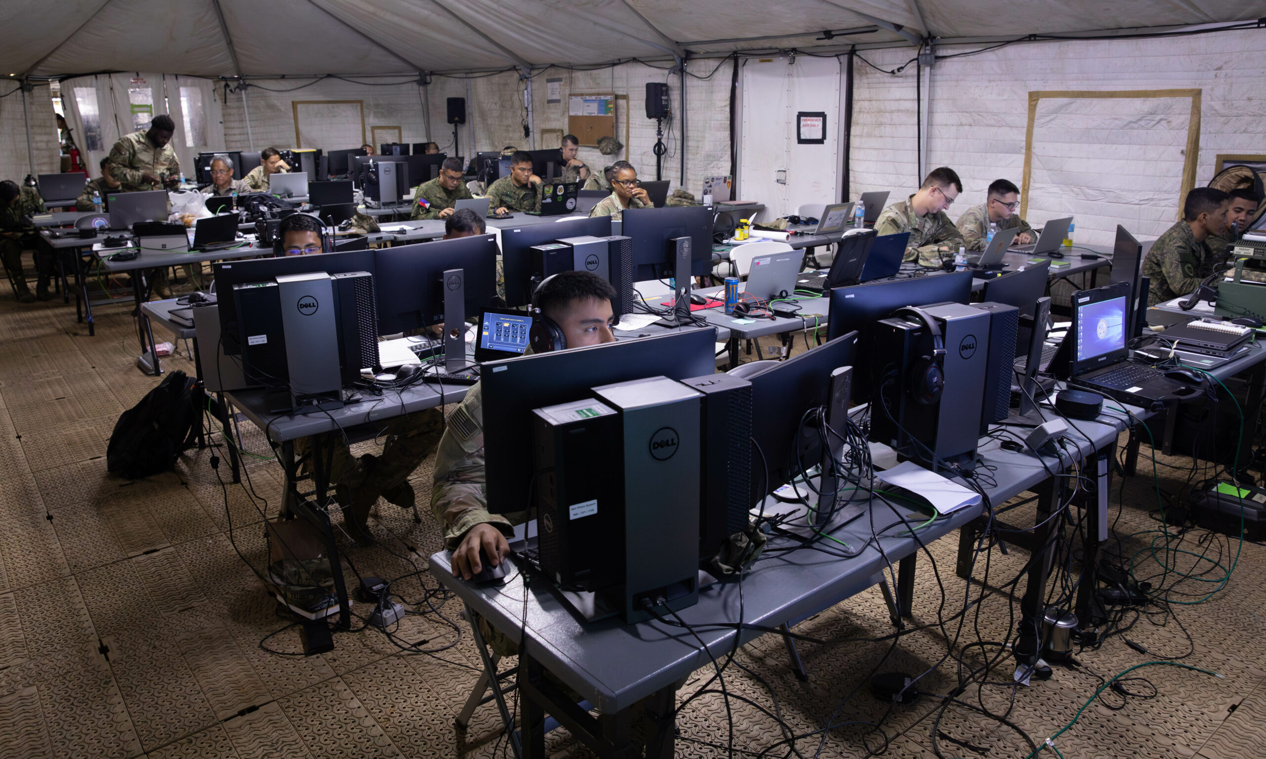 U.S. and Philippines Army soldiers work in the Joint Operations Center during the Joint Pacific Multinational Readiness Center-Exportable (JPMRC-X) exercise on Fort Magsaysay, Philippines, 31 May 2024. This iteration of JPMRC-X marks the first deployment to the Philippines, which will enable and assist the Philippines Army and the Armed Forces of the Philippines in building combat training center locations within the Philippines. The JPMRC-X is a Department of the Army initiative consisting of a deployable package of personnel and equipment designed to support training exercises across the Pacific. (U.S. Army National Guard photo by Staff Sgt. Tommie Berry)