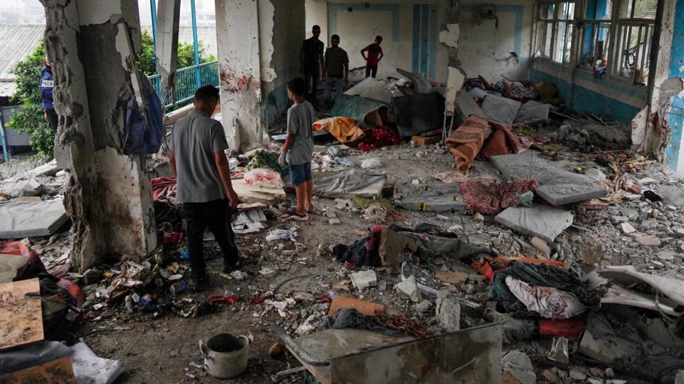 Palestinians look through a UN school that was hit during Israeli bombardment in Nuseirat, in the central Gaza Strip, on June 6, 2024.
