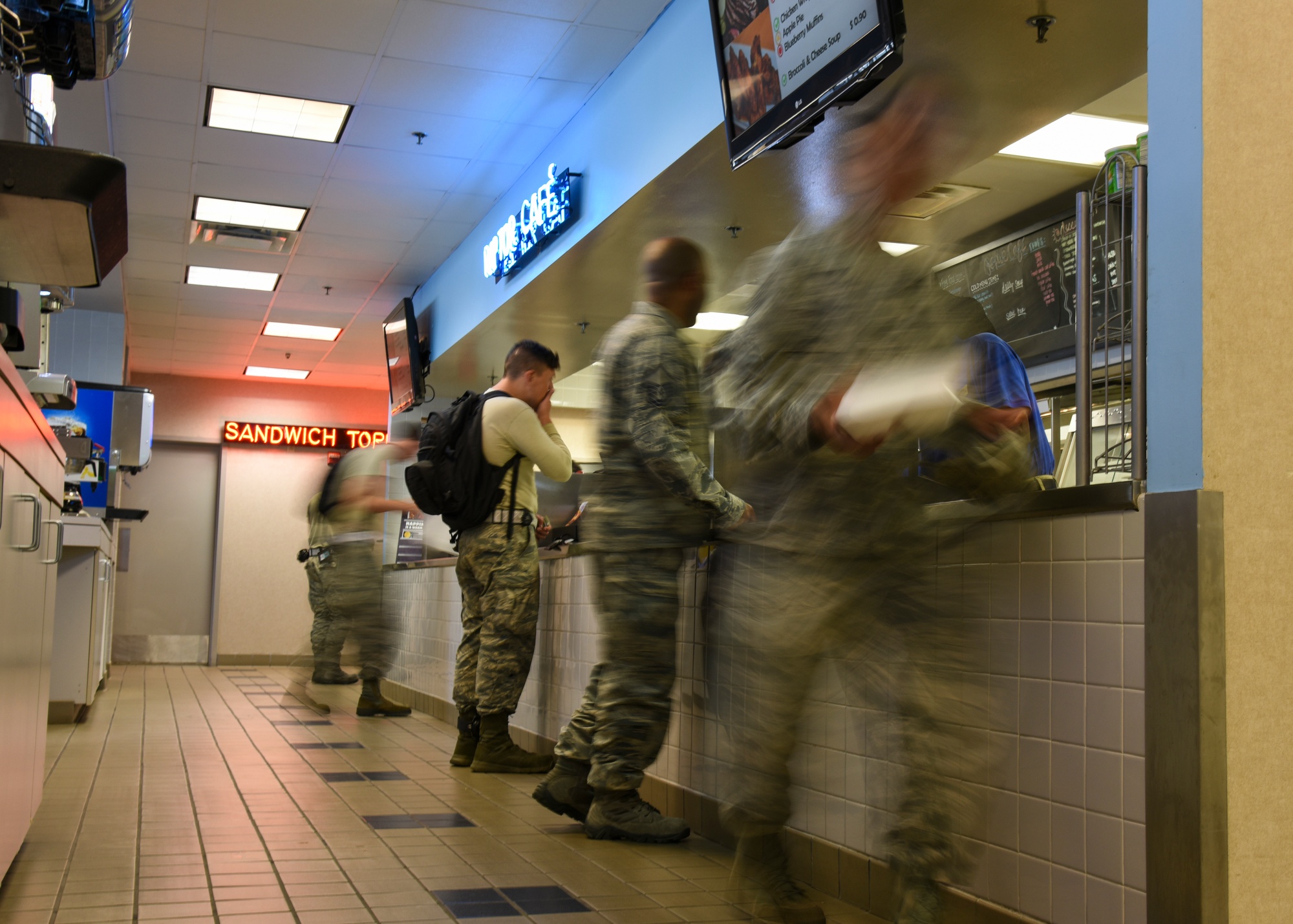 U.S. Air Force 1st Maintenance Squadron Airmen pick up their lunch at the Raptor Café at Joint Base Langley-Eustis, Va., Sept. 9, 2017. A variety of meal options are offered on a 21-day rotation menu for Airmen who wish to dine-in; these meals include main entrees, self-serve wrap bar, soup and salad options, as well as, sandwich specials and desserts. (U.S. Air Force photo by Airman 1st Class Anthony Nin Leclerec)