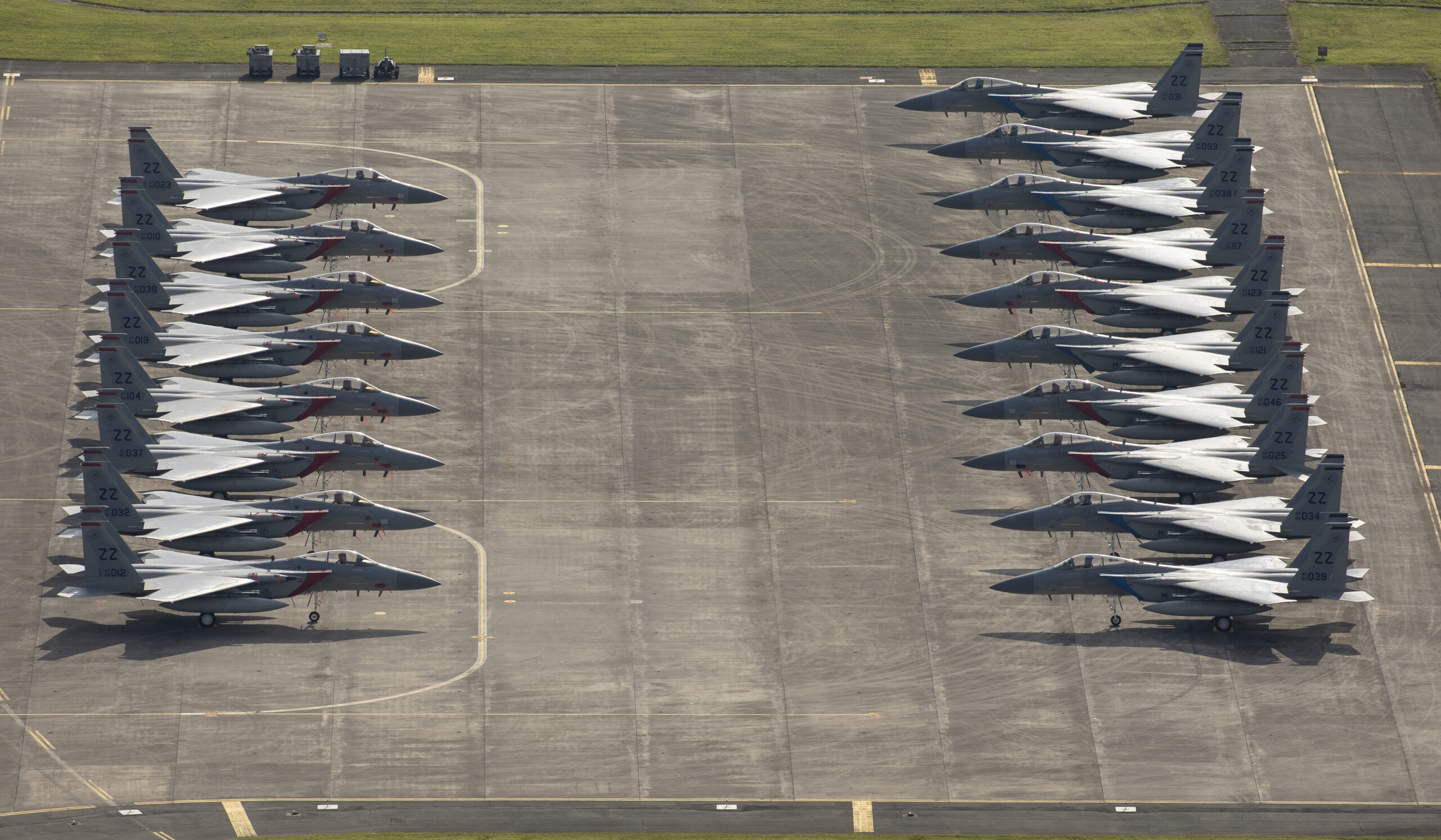 Eighteen U.S. Air Force F-15 Eagles from Kadena Air Base are parked on the ramp, July 9, 2018, at Yokota Air Base, Japan. The F-15s evacuated due to Typhoon Maria. This is the most aircraft to ever evacuate to Yokota AB from Kadena AB. (U.S. Air Force photo by Yasuo Oaskabe)