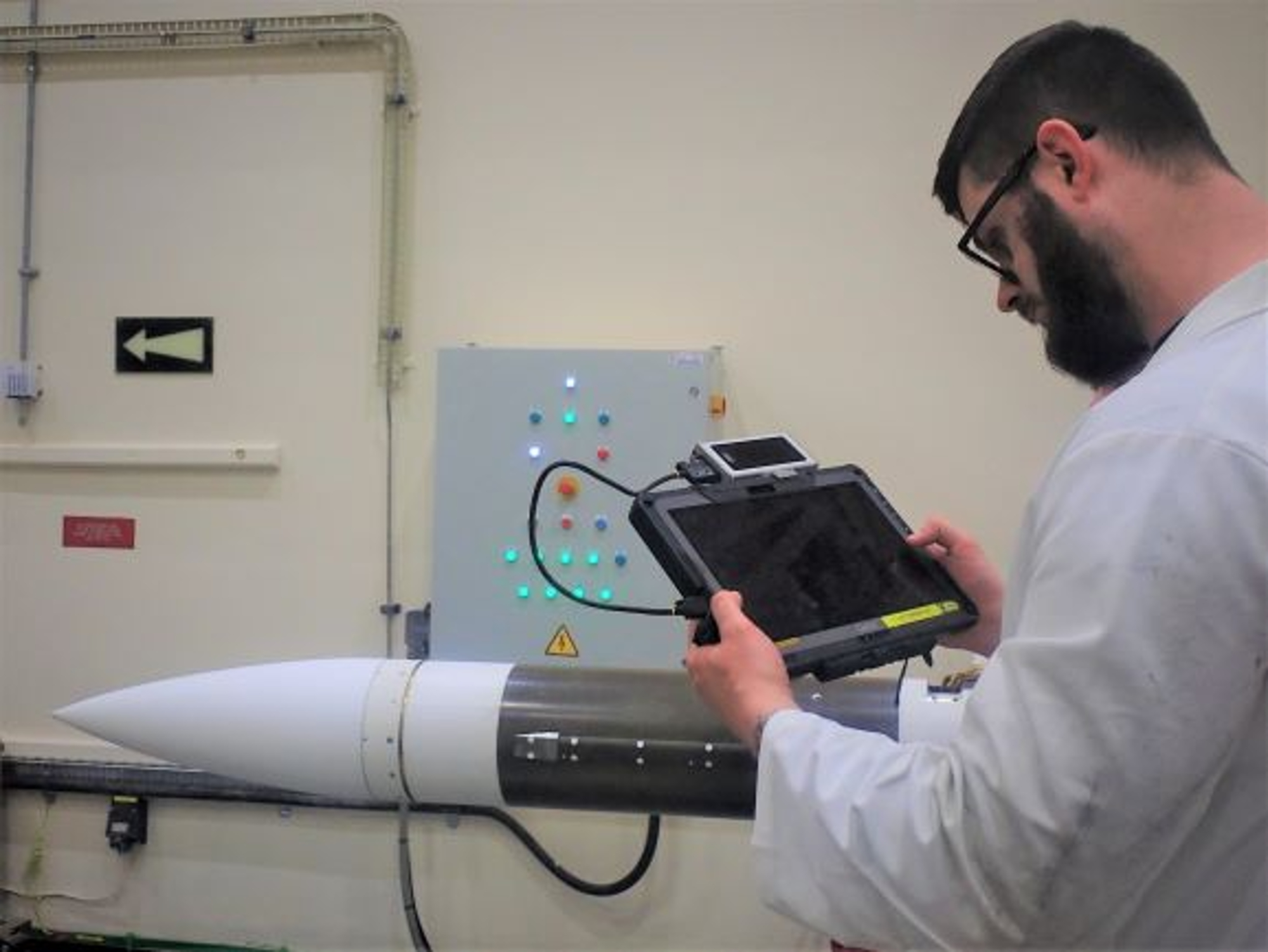 Weapons developer checks online data through a device
